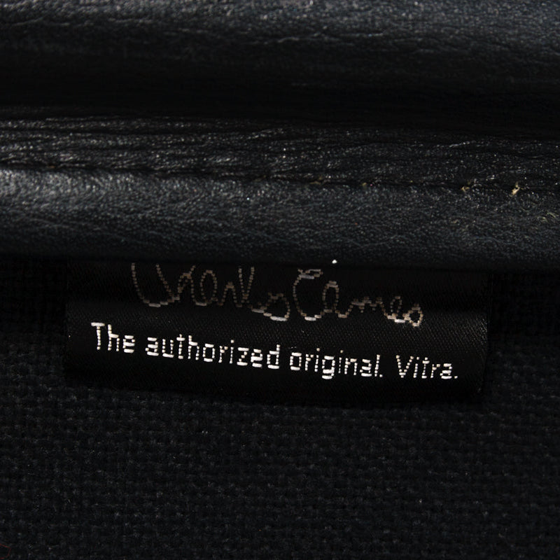 Vitra Charles Eames Soft Pad Chair label: "The authorized original. Vitra." on black leather.