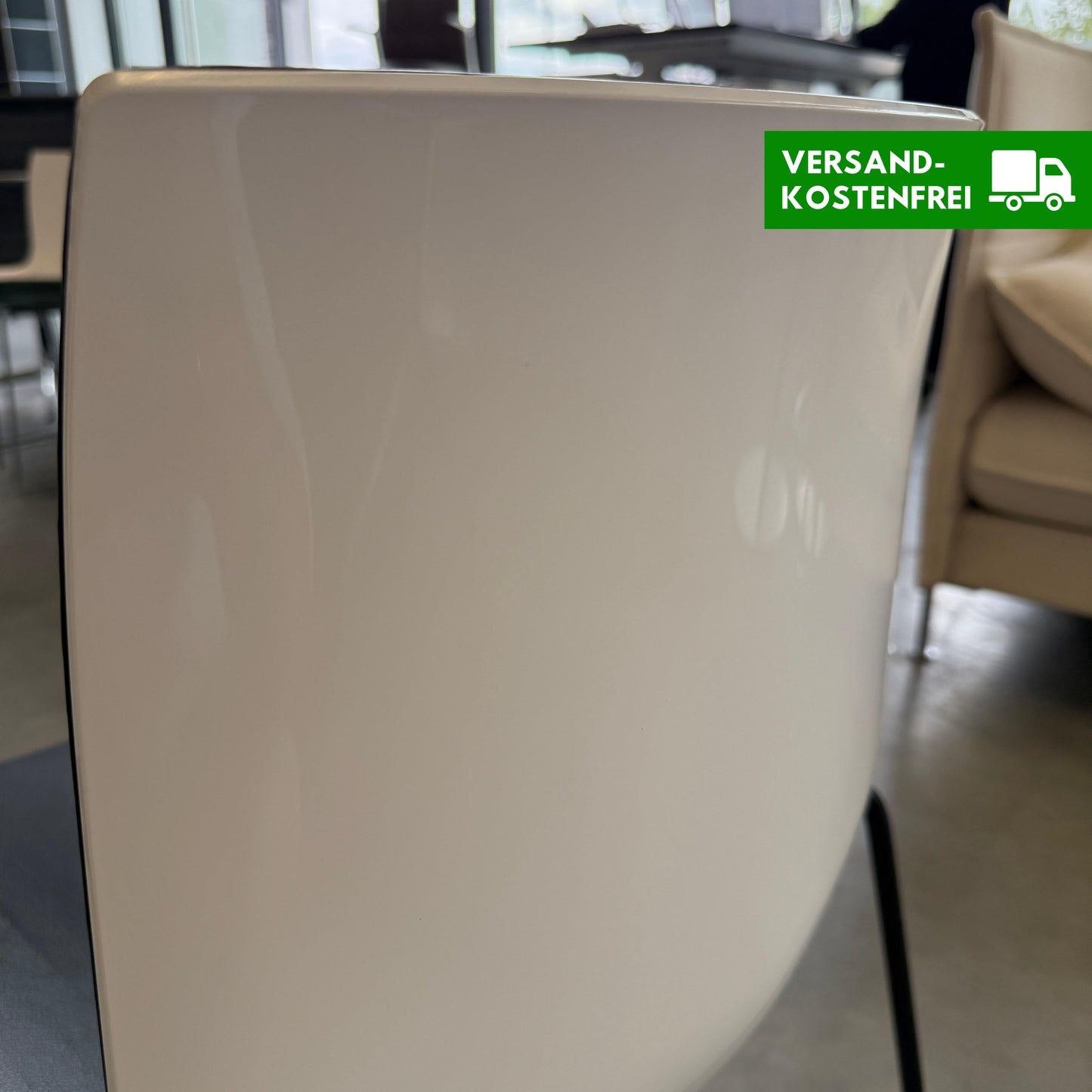 Arper Catifa 46 chair with black leather seat and white shell on metal four-leg frame