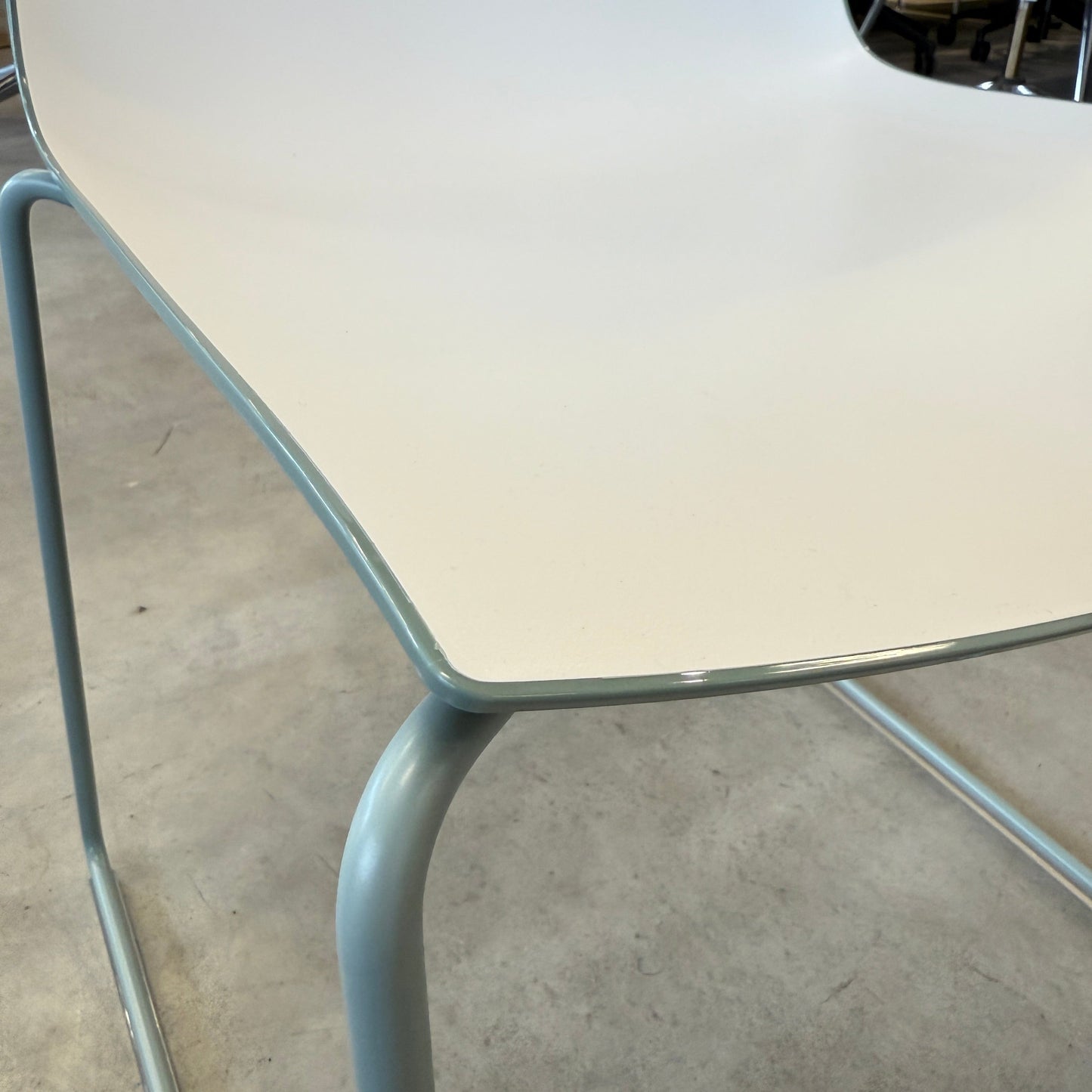 Arper Catifa 46 chair with white seat and dove blue sled base on concrete floor