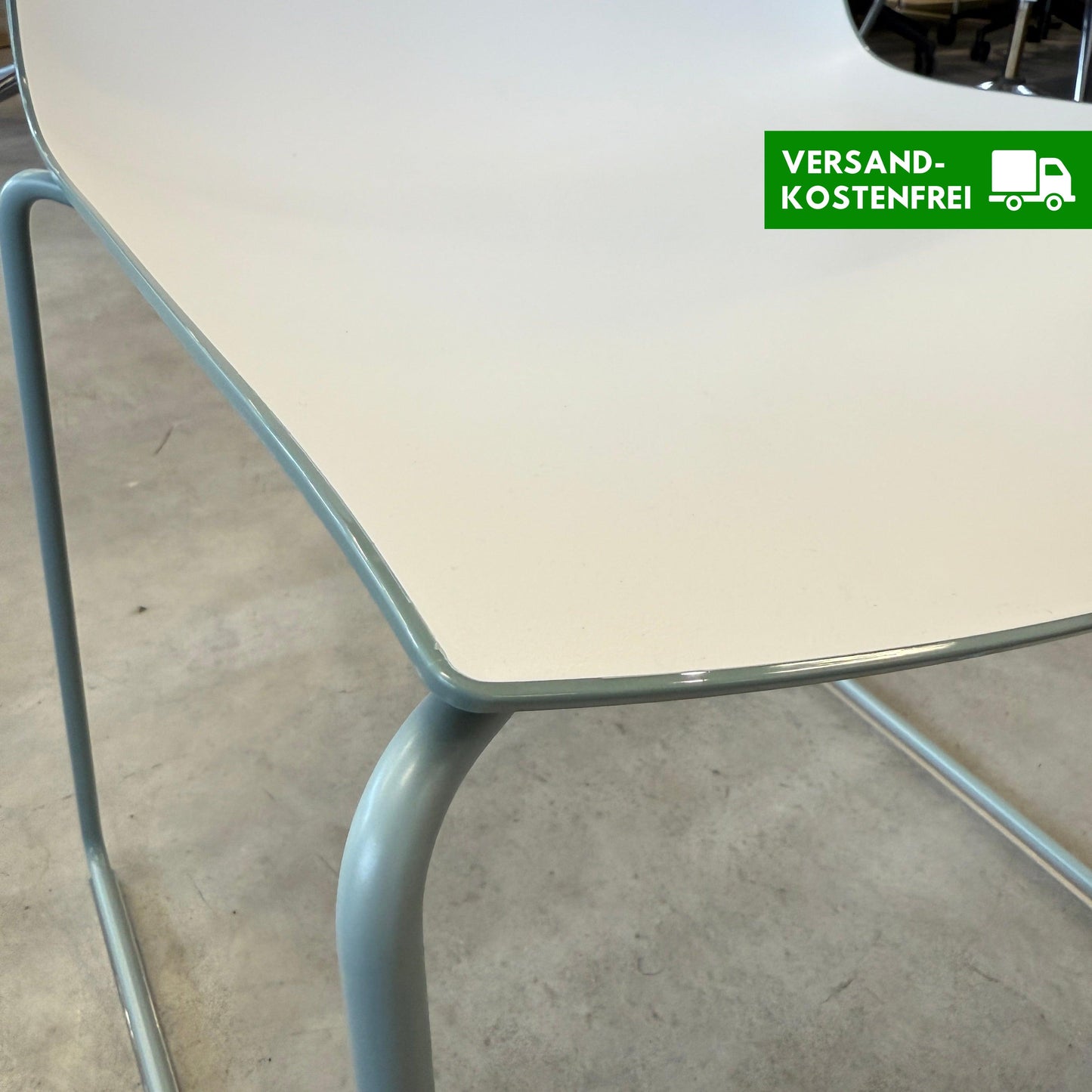 Arper Catifa 46 chair with white seat and dove blue sled base on concrete floor