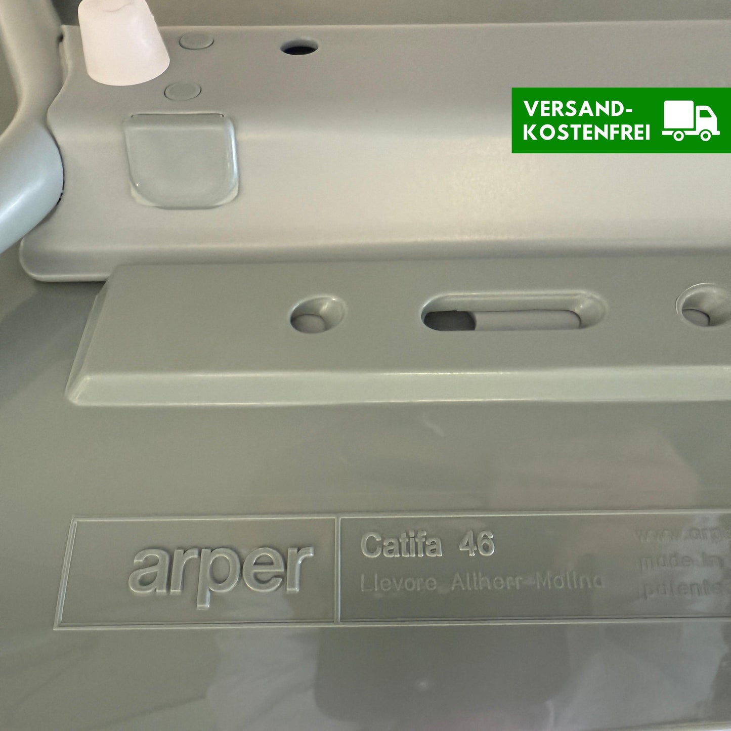 Close-up of Arper Catifa 46 chair label showing model and designer name on light gray surface