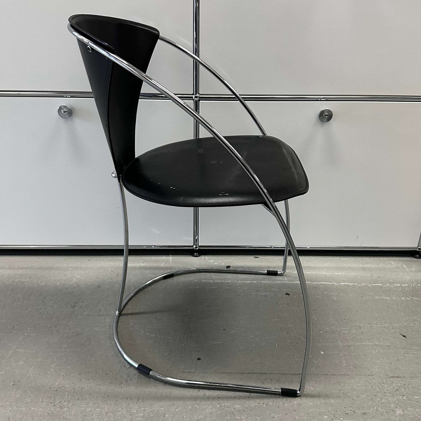 Black leather and chrome steel frame chair Arrben Italy Linda with curved modern design and comfortable seat