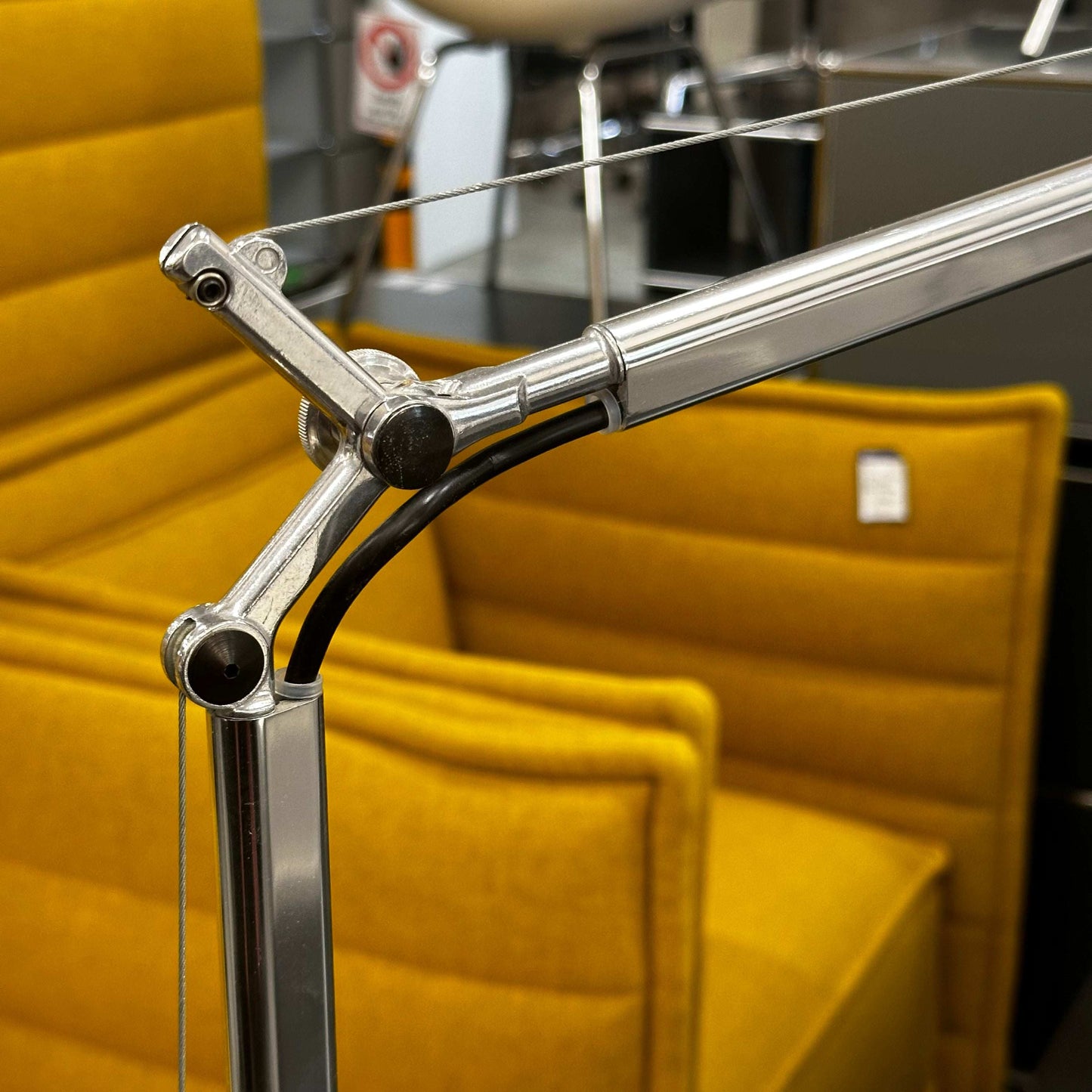 Close-up of Artemide Tolomeo Tavolo silver desk lamp arm without base or clamp, showing used condition with minor wear.