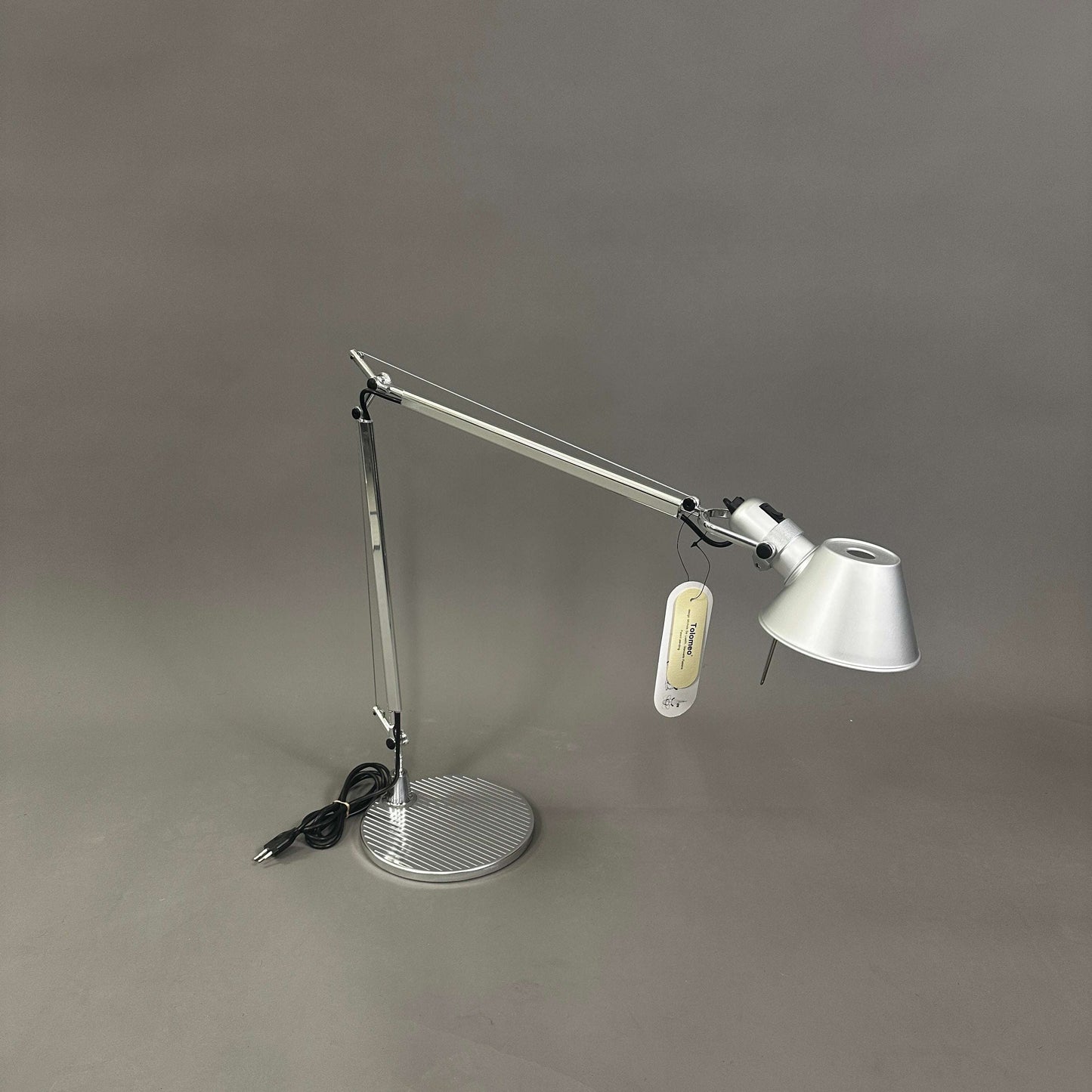 Artemide Tolomeo Tavolo desk lamp with polished aluminum body and adjustable arm on round base