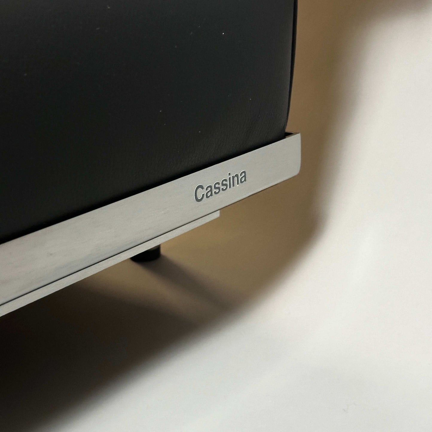 Close-up of Cassina LC2 3-seater leather sofa frame with Cassina logo engraving