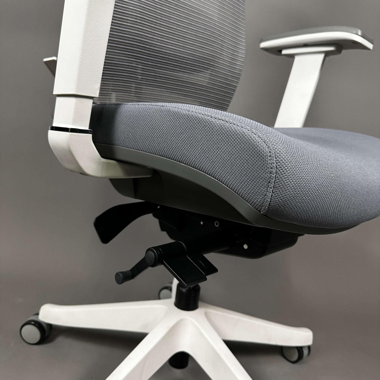 Ergonomic office chair Ergo1 with white aluminum frame, gray fabric seat, and adjustable gray mesh backrest and headrest