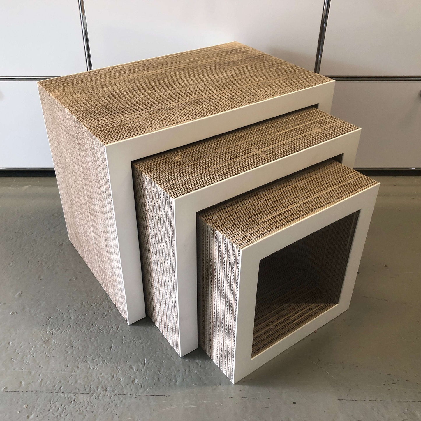 Frank Gehry Low Table Set three-piece nesting side tables made of corrugated cardboard with white matte lacquered wood edges