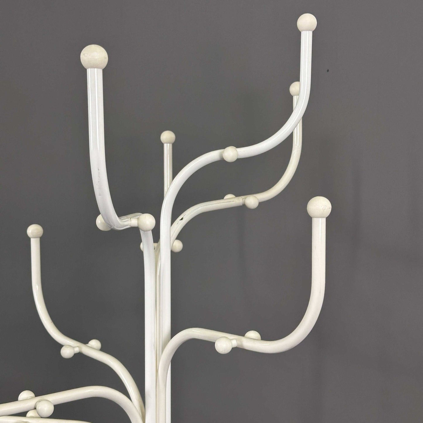 White Fritz Hansen Coat Tree with multiple curved hooks on gray background