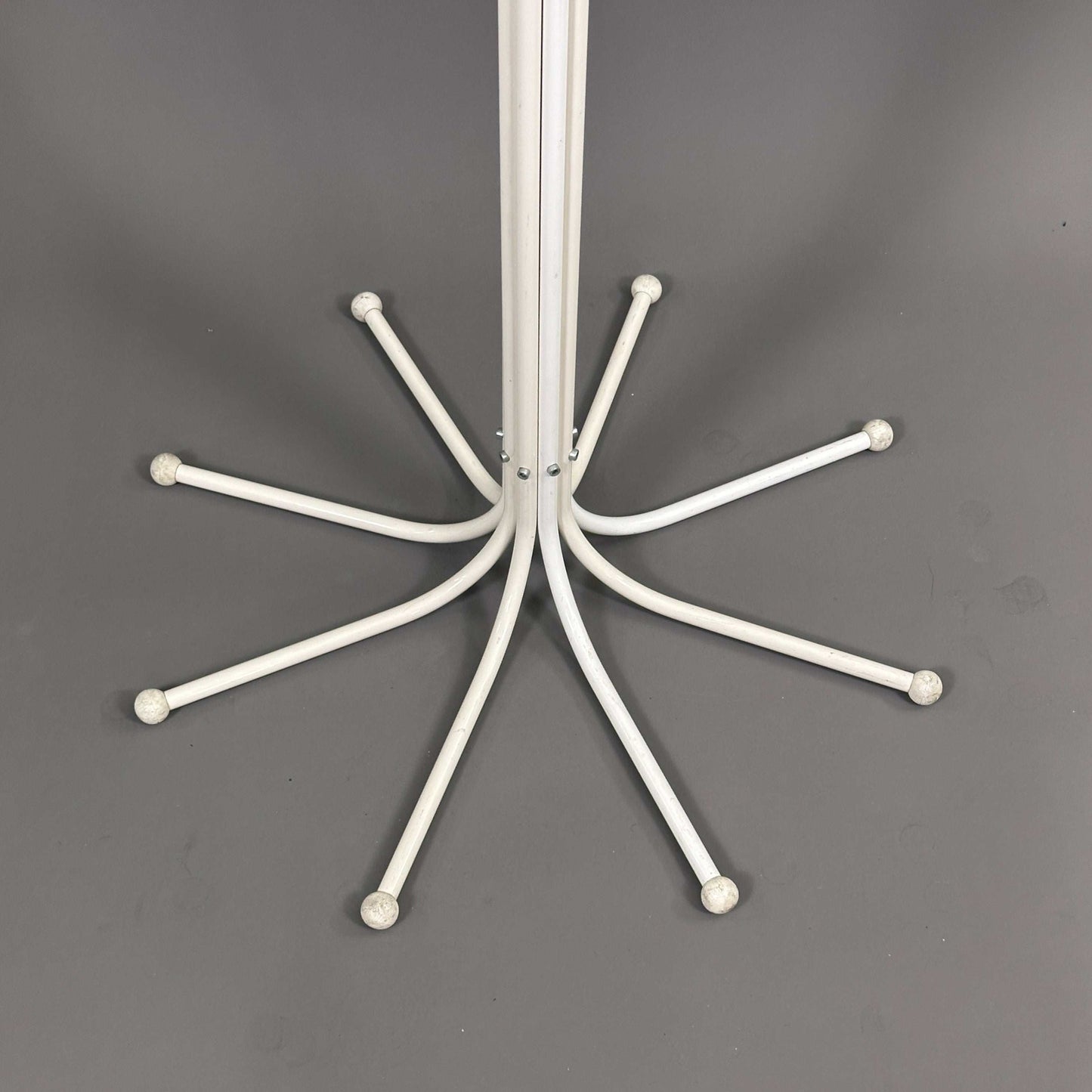 White Fritz Hansen Coat Tree stand with curved hooks on gray background