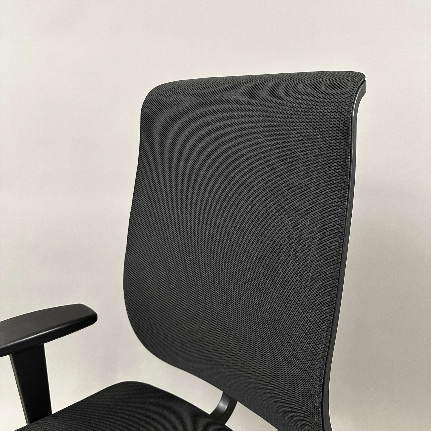 Black Girsberger Reflex office chair with flexible mesh backrest and padded fabric seat