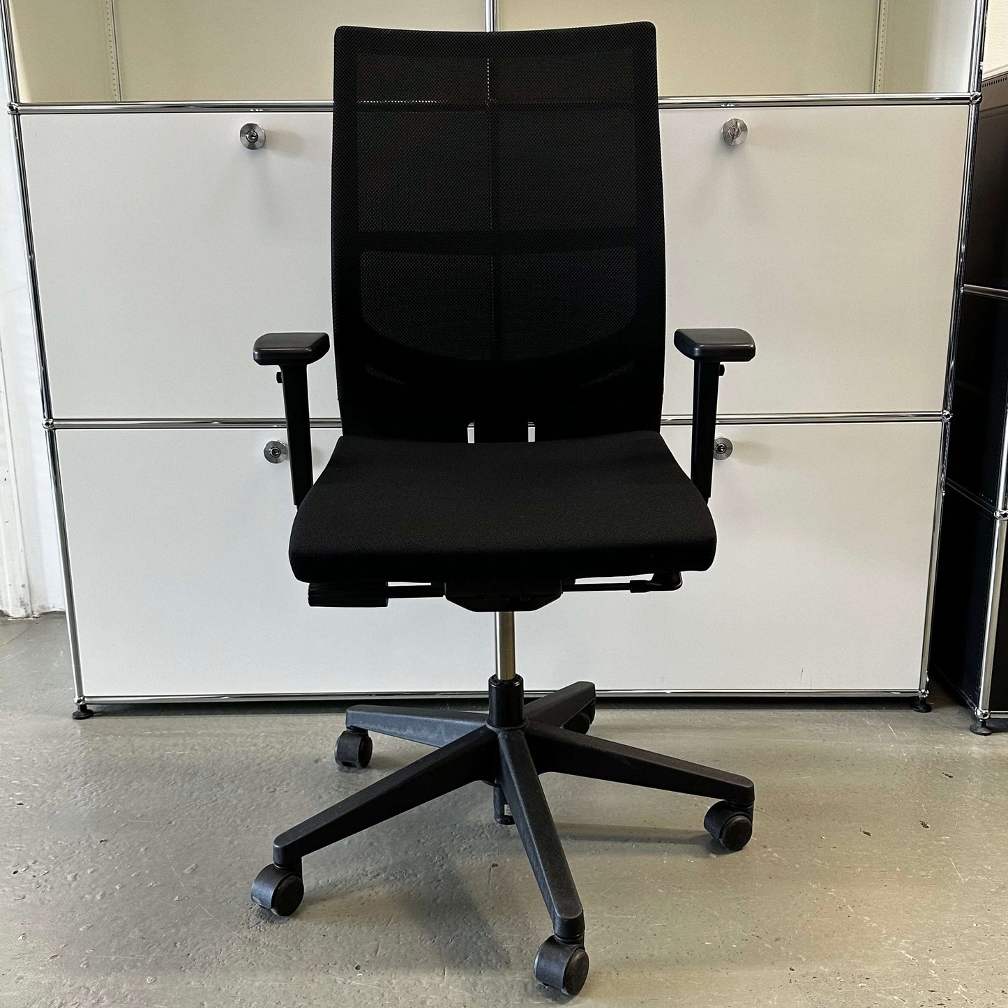 Haworth Comforto 39 black office chair with mesh backrest, adjustable armrests, seat height, and black base with casters