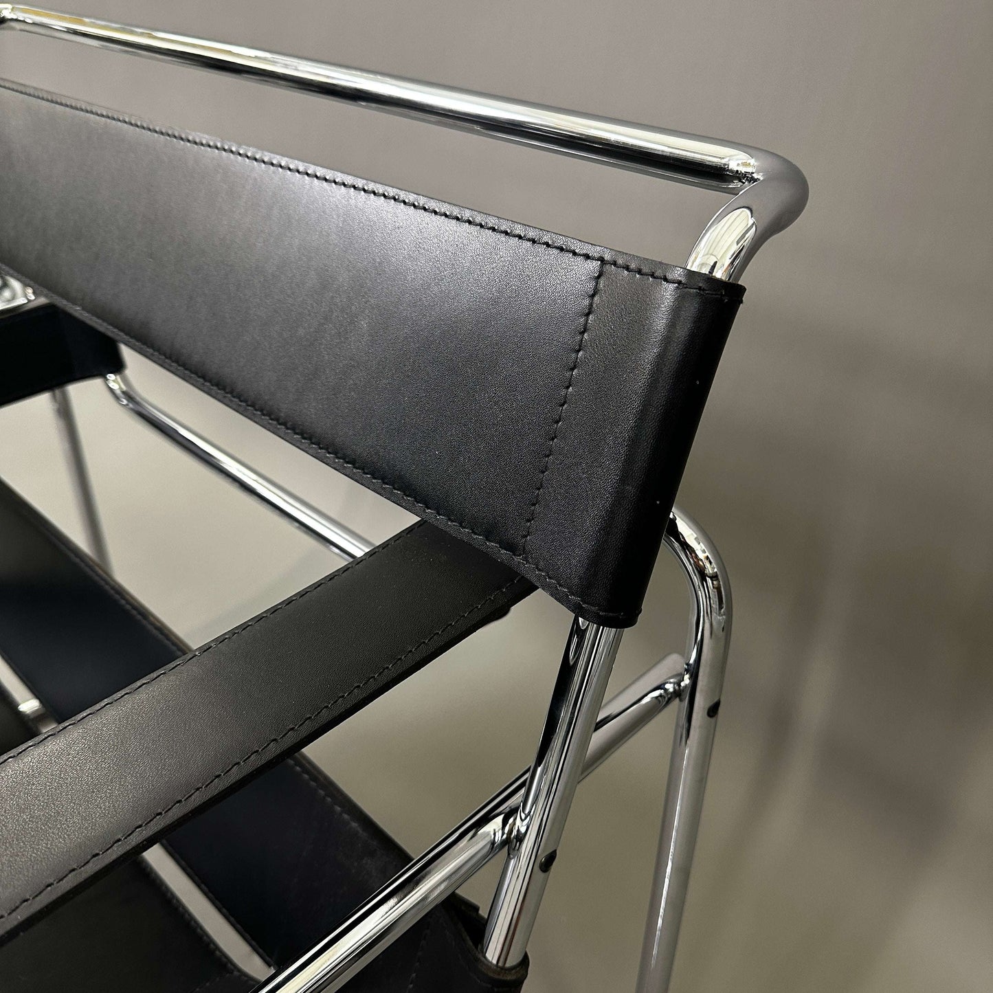 Close-up of Knoll Wassily Chair with black leather straps and chrome frame detailing