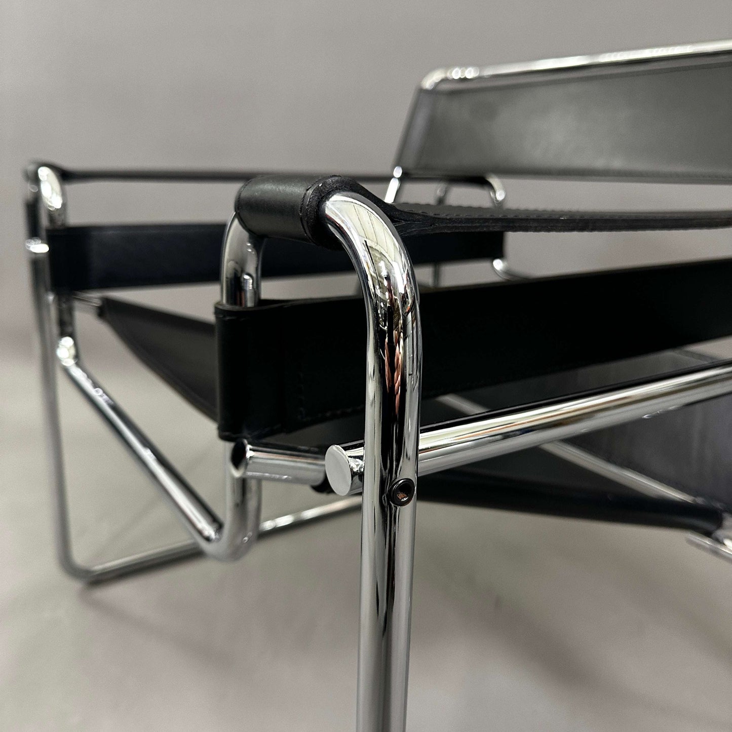 Close-up of a black leather Knoll Wassily Chair with chrome frame details