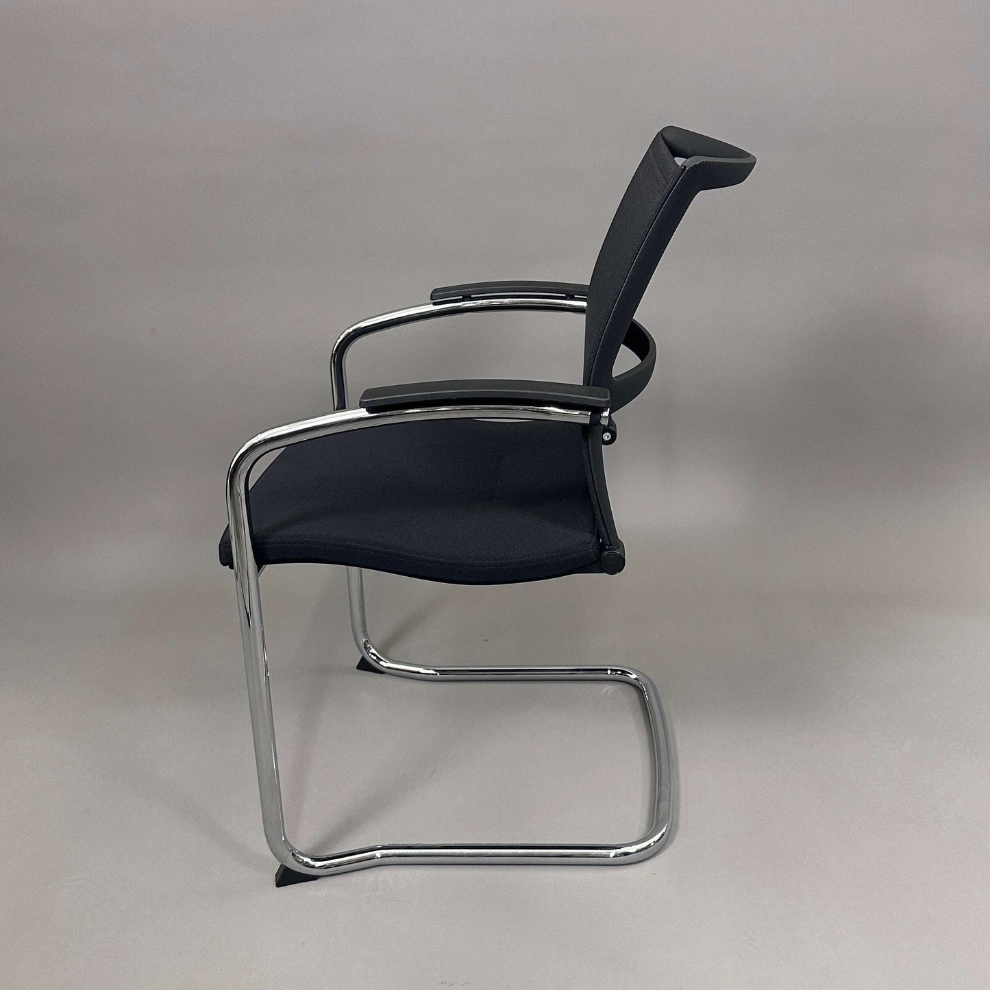 Sedus OpenUp Freischwinger chair with black mesh backrest and chrome cantilever frame
