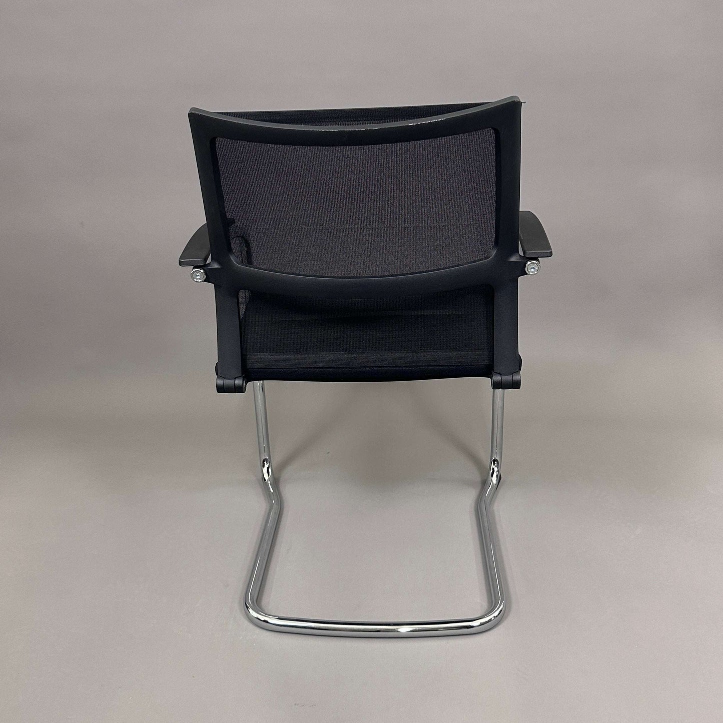 Sedus OpenUp Freischwinger chair with black mesh backrest and chrome cantilever frame viewed from the back