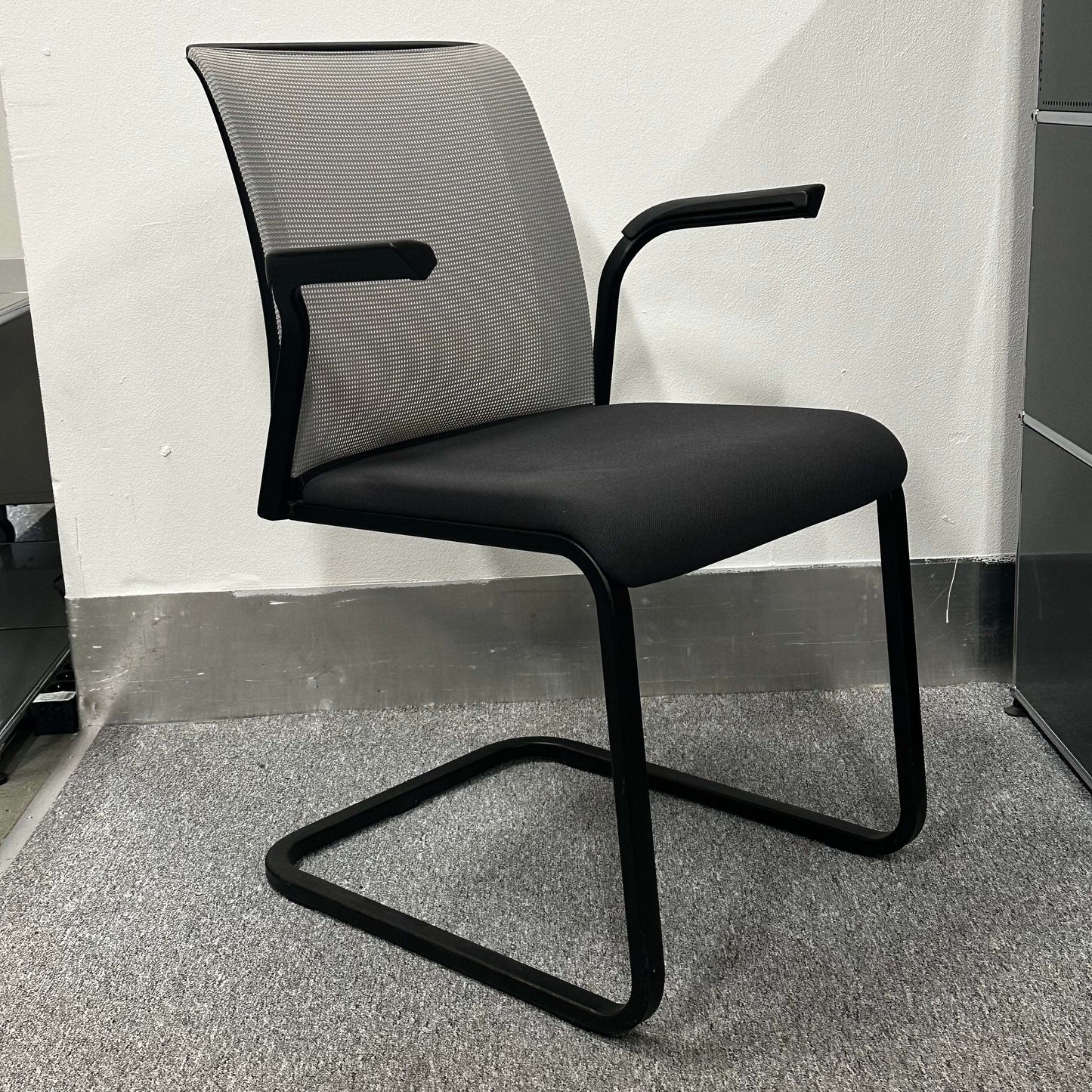 Steelcase Eastside Freischwinger office chair with black seat and mesh backrest on cantilever frame
