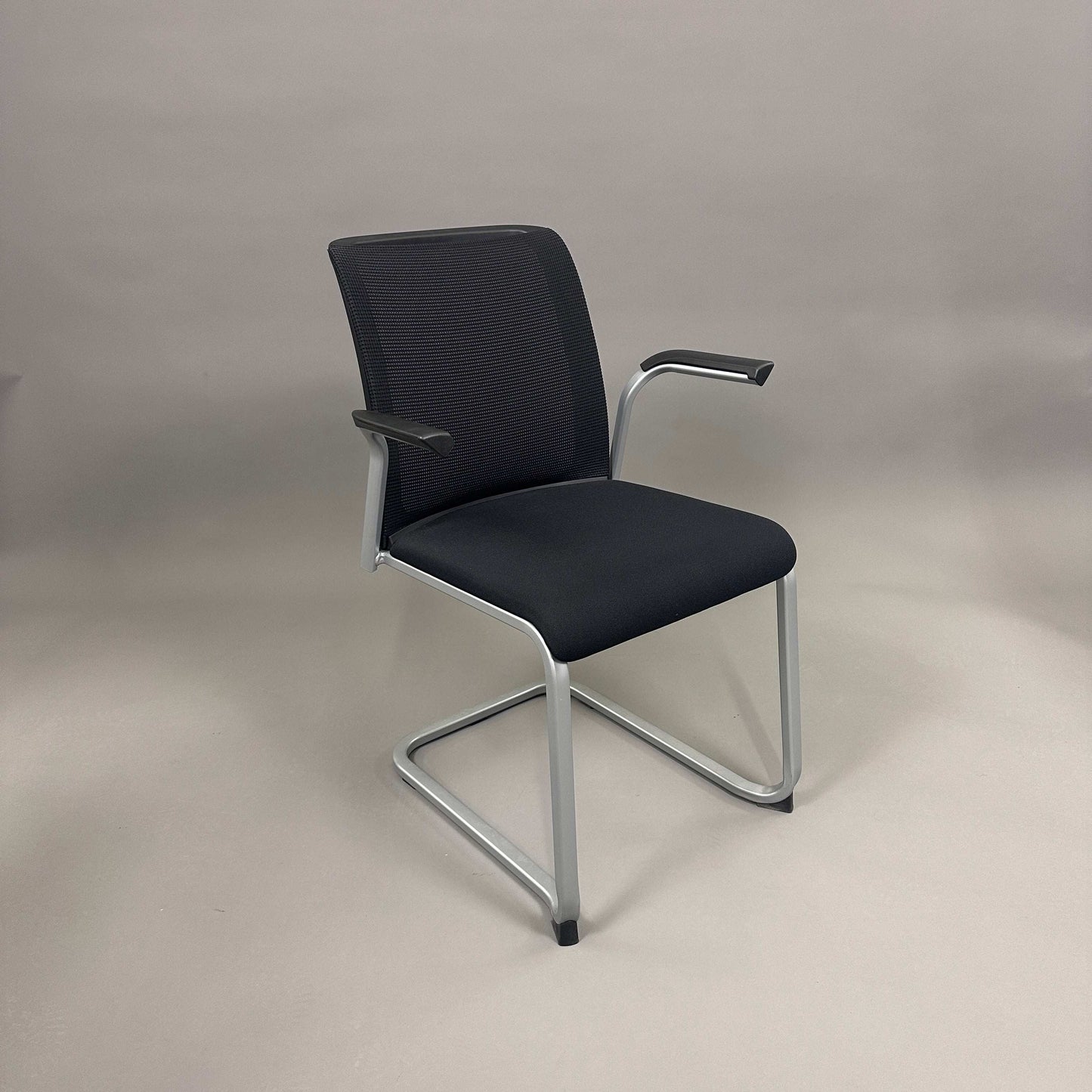 Steelcase Northside meeting chair with black mesh back and silver frame, stackable office chair
