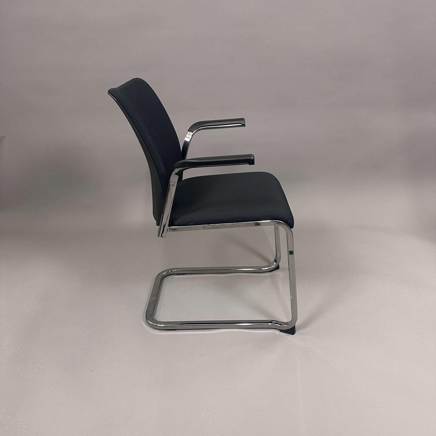 Steelcase Northside black upholstered meeting chair with chrome frame and armrests, stackable design