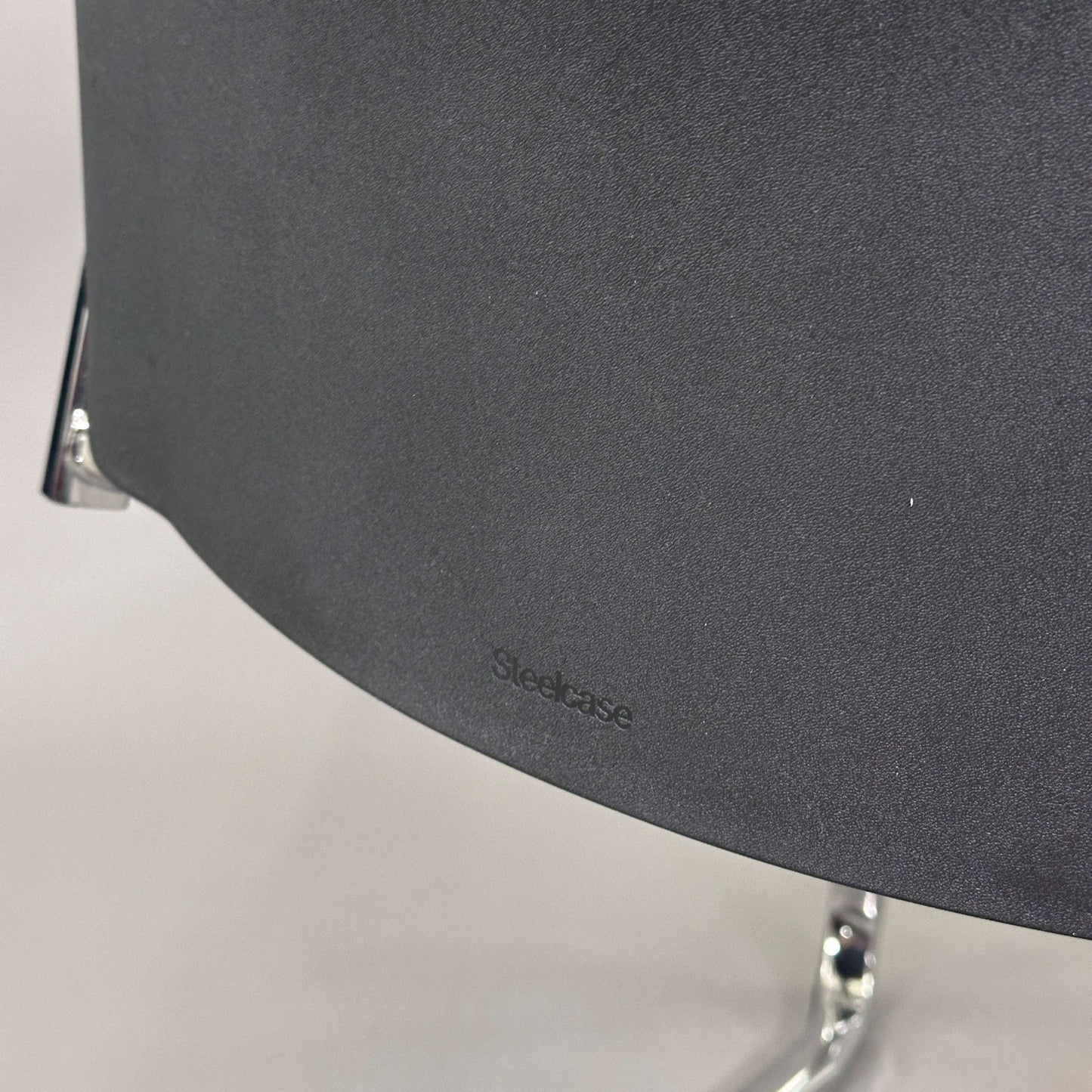 Close-up of Steelcase Northside Besprechungsstuhl black padded backrest with chrome frame detail