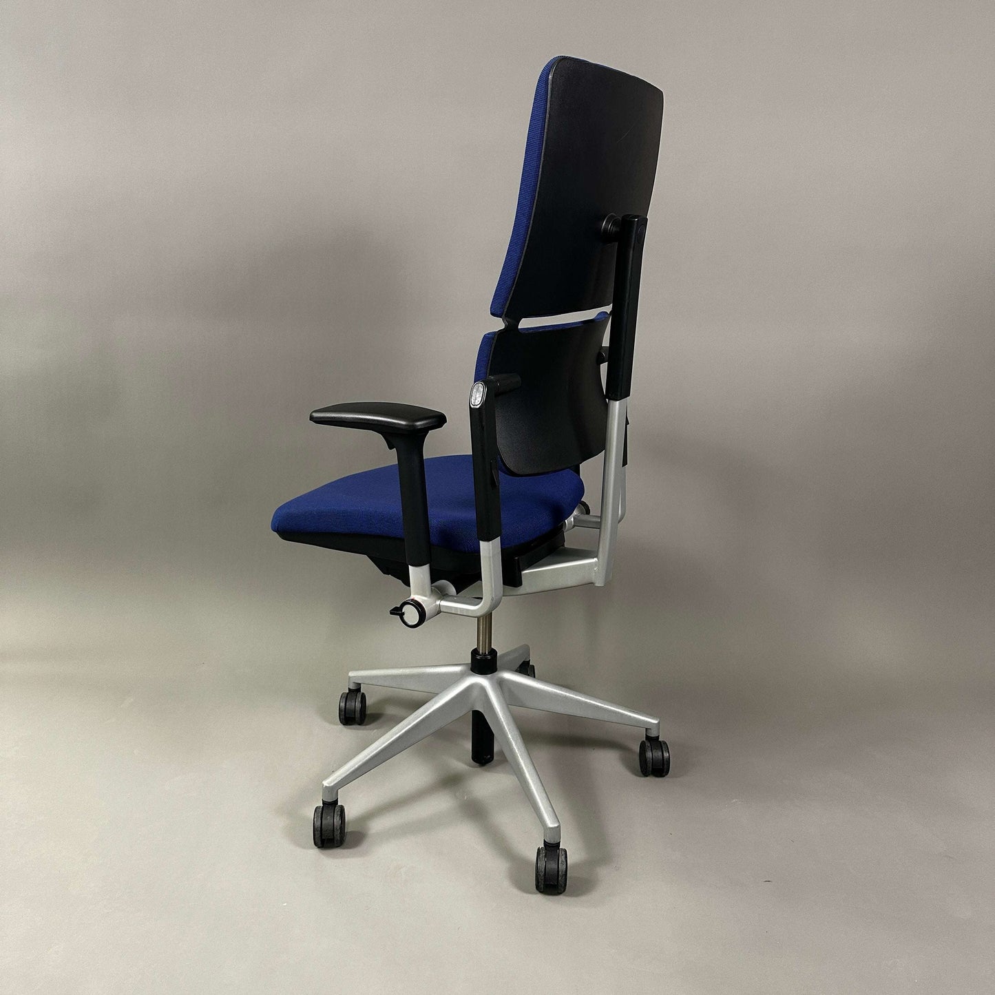 Steelcase Please ergonomic office chair in blue with adjustable height, armrests, and lumbar support on silver metal frame