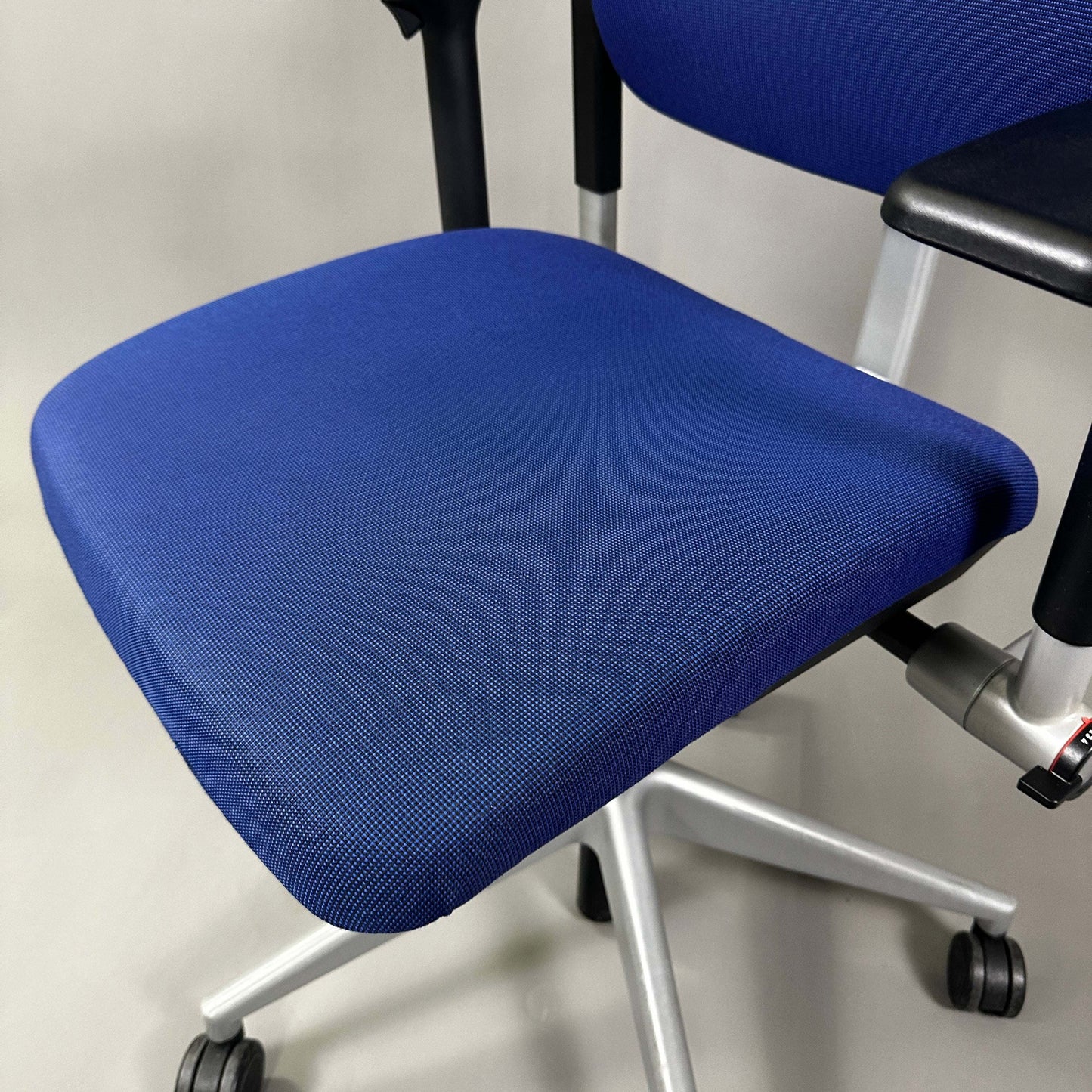 Steelcase Please blue ergonomic office chair with adjustable features and silver metal frame