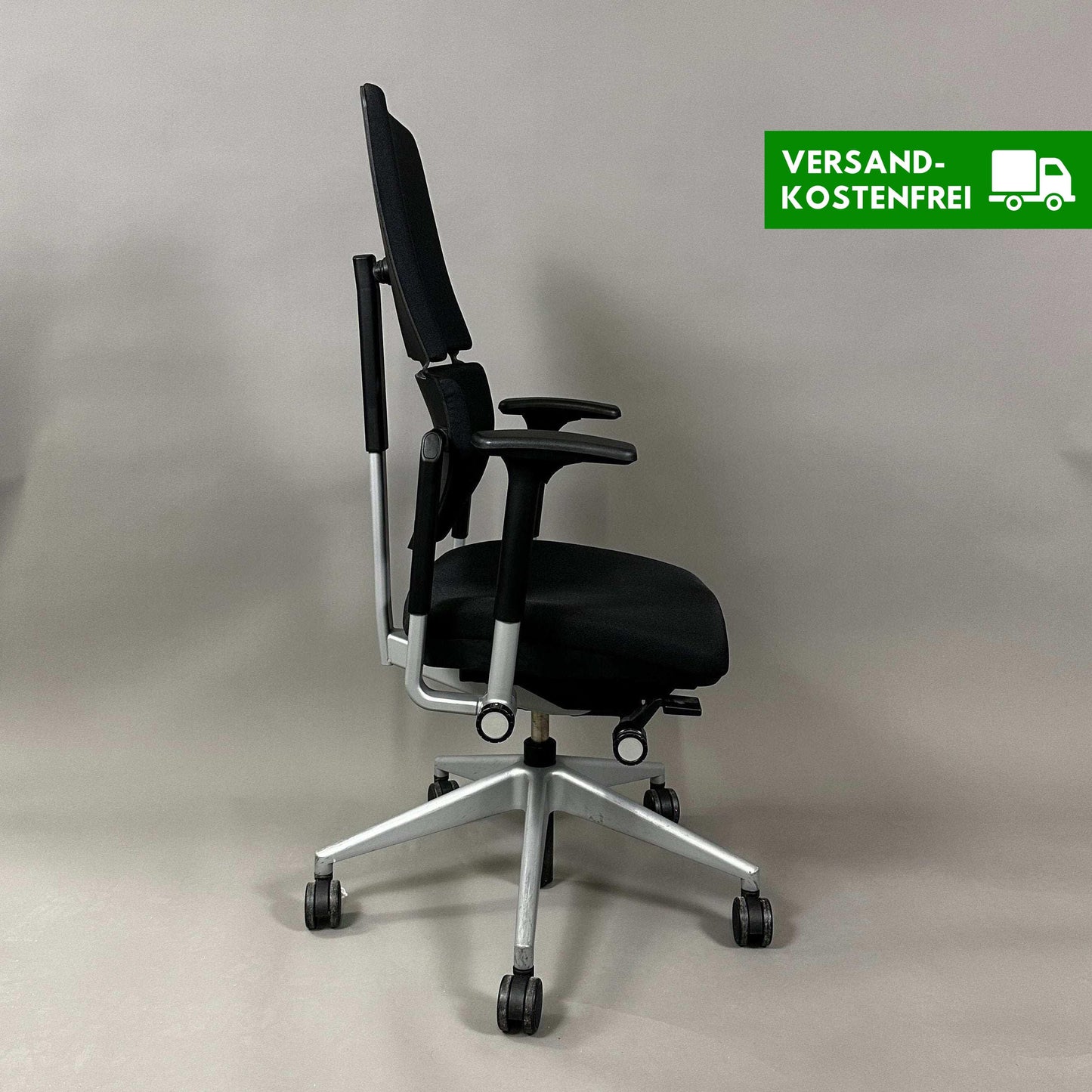 Side view of Steelcase Please V2 ergonomic office chair in black with silver base and adjustable features