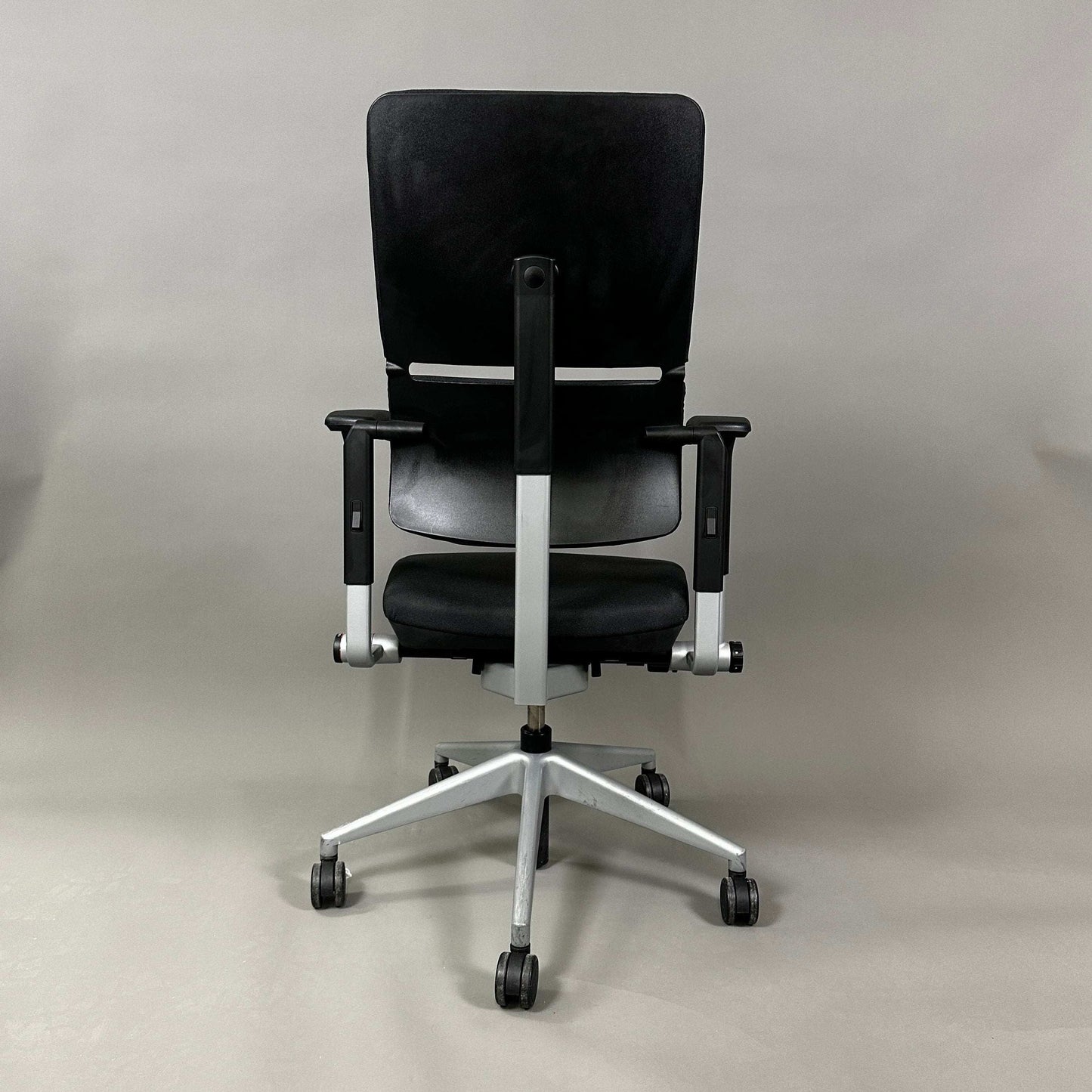 Steelcase Please ergonomic black office chair with silver frame and adjustable features viewed from the front