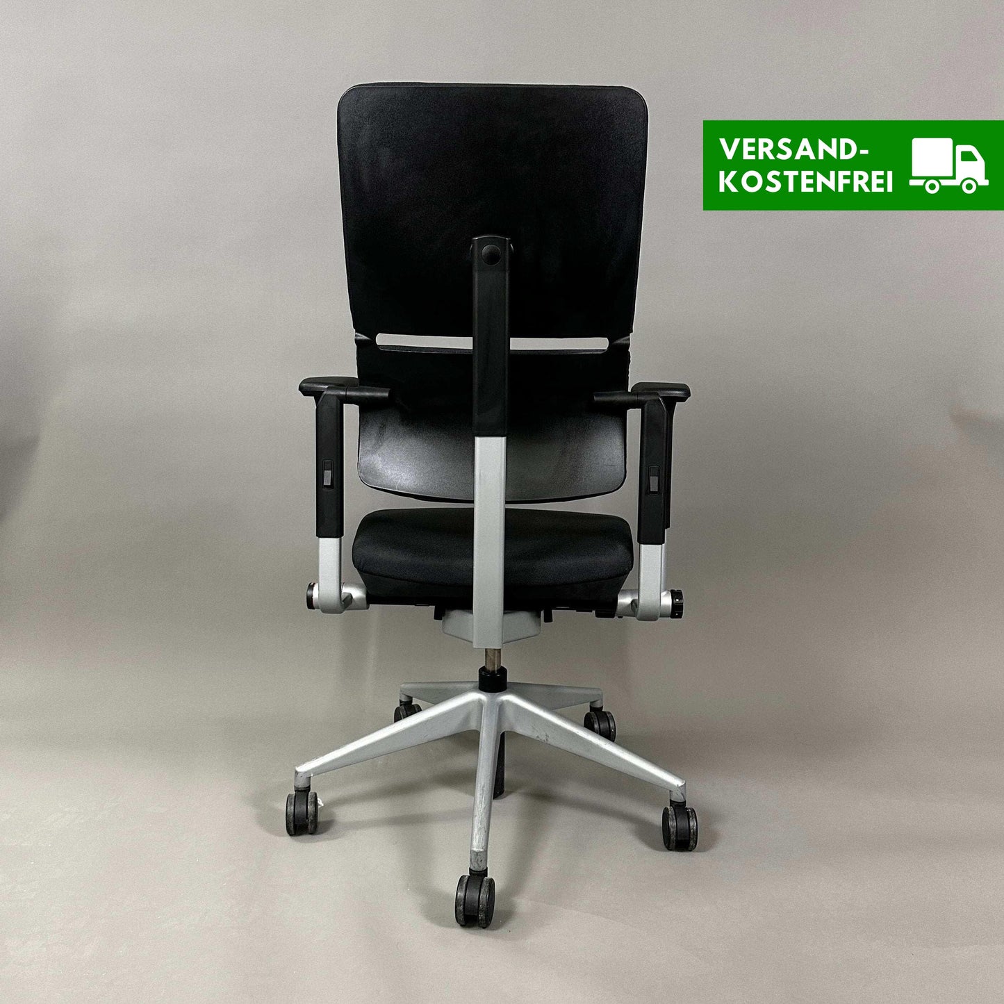 Steelcase Please ergonomic black office chair with silver frame and adjustable features viewed from the front