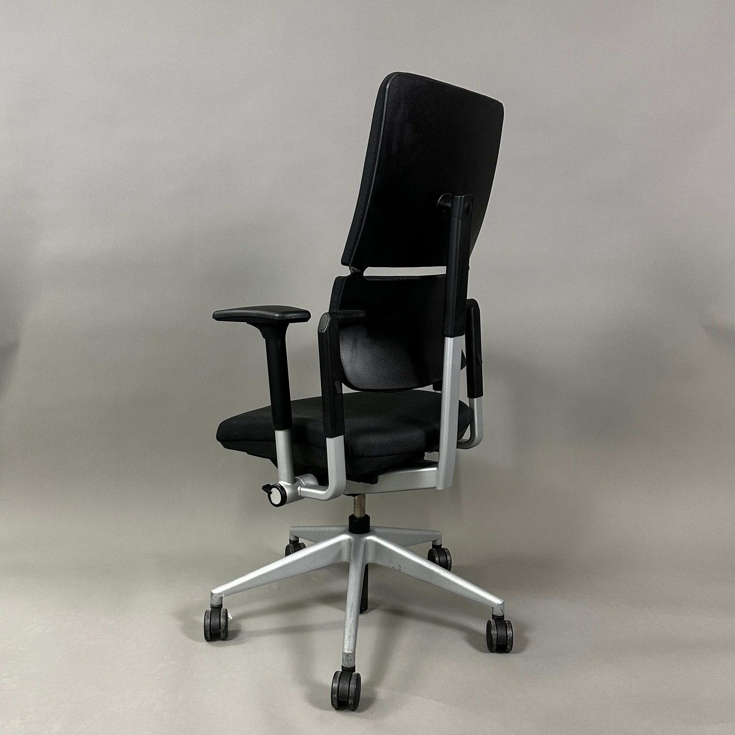 Steelcase Please ergonomic office chair in black and silver with adjustable armrests, lumbar support, and height-adjustable backrest
