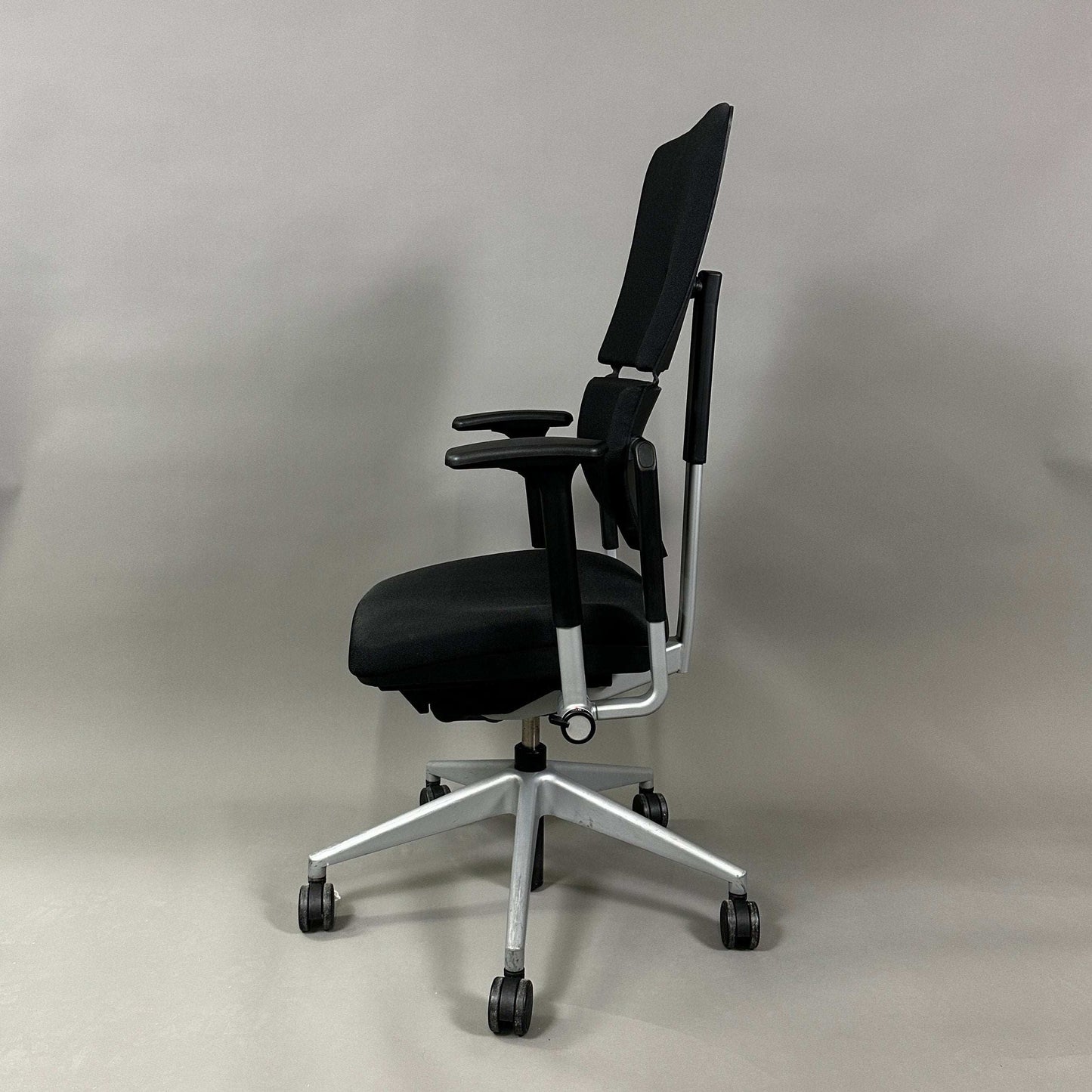 Steelcase Please ergonomic office chair in black with silver frame and adjustable armrests, lumbar support, and height-adjustable backrest