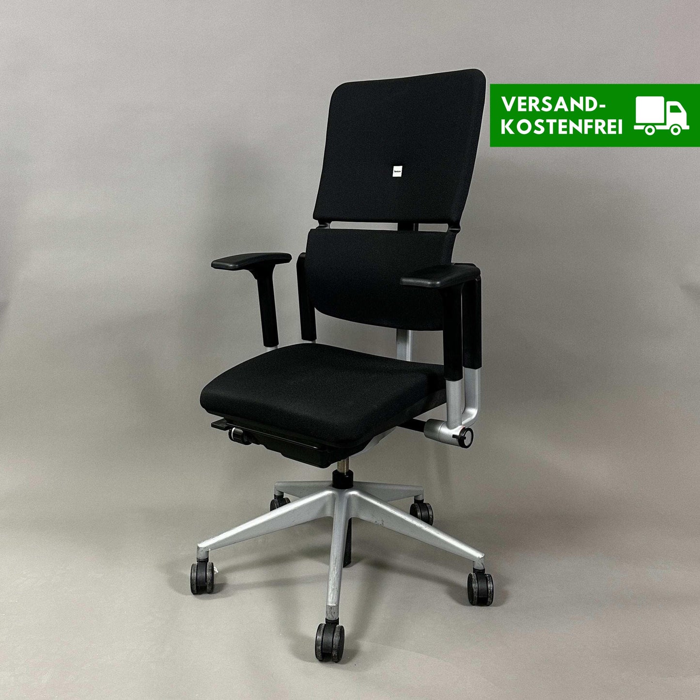 Steelcase Please V2 ergonomic office chair in black with adjustable lumbar support, seat depth, armrests, and backrest on silver base with casters