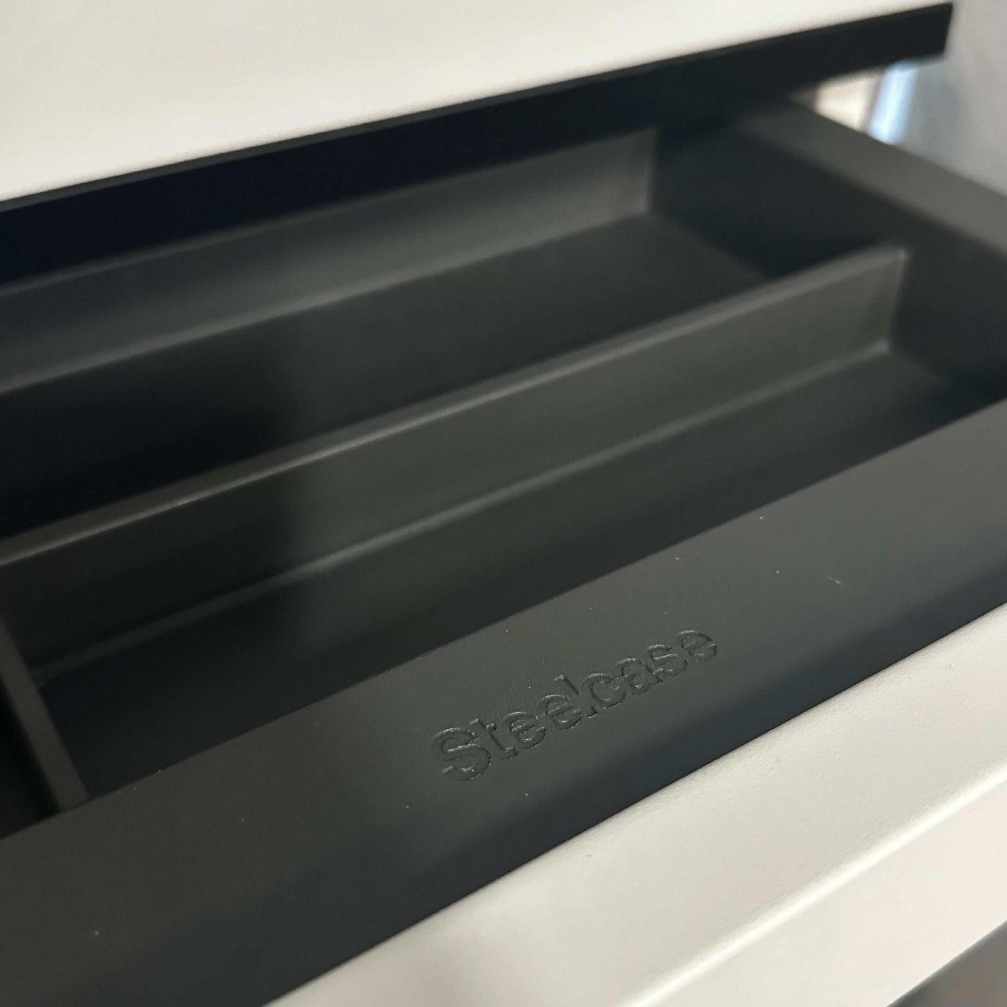 Steelcase Rollcontainer white with black edge close-up of open drawer compartments