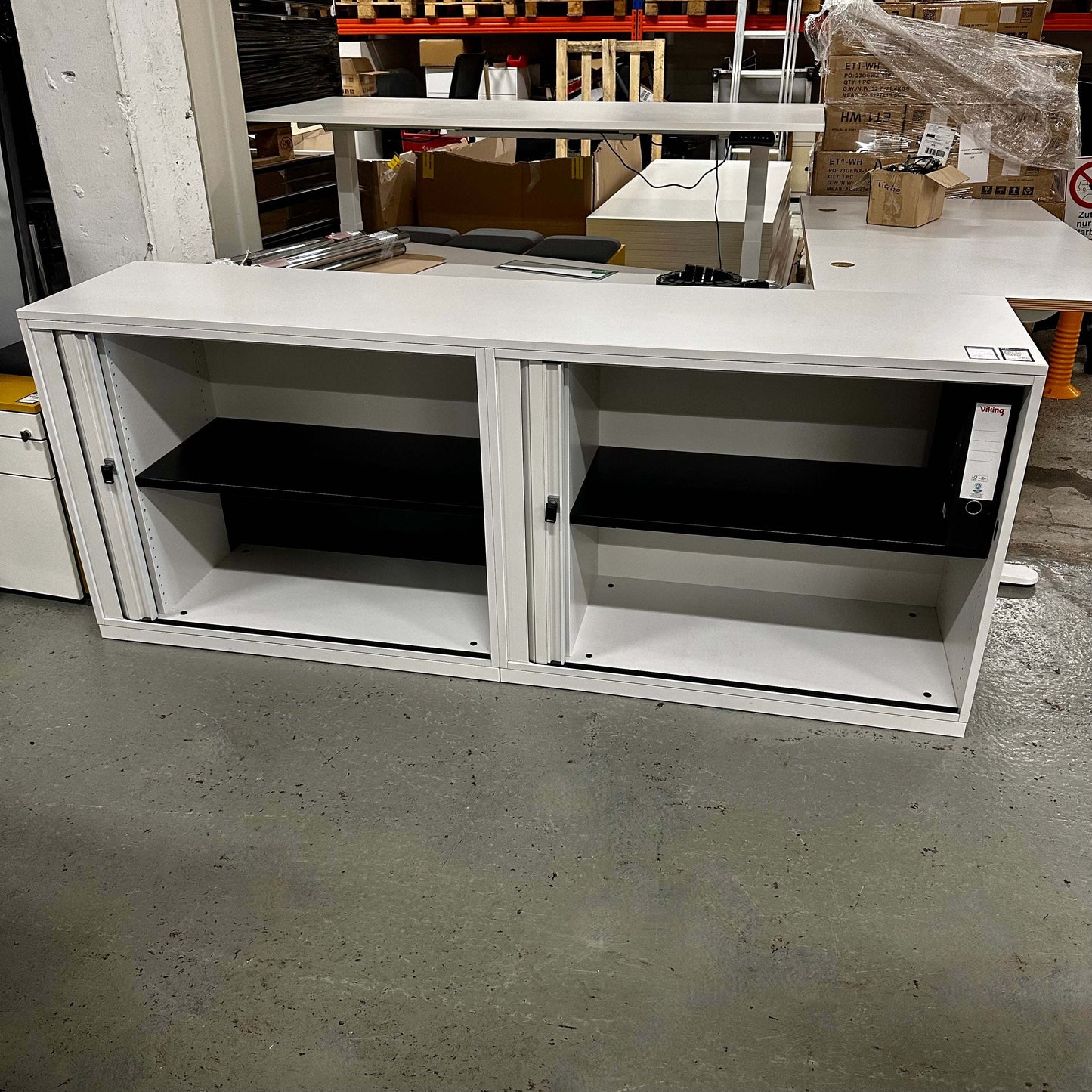 White Steelcase Sideboard 2OH with two open compartments and black interior shelves in warehouse setting.