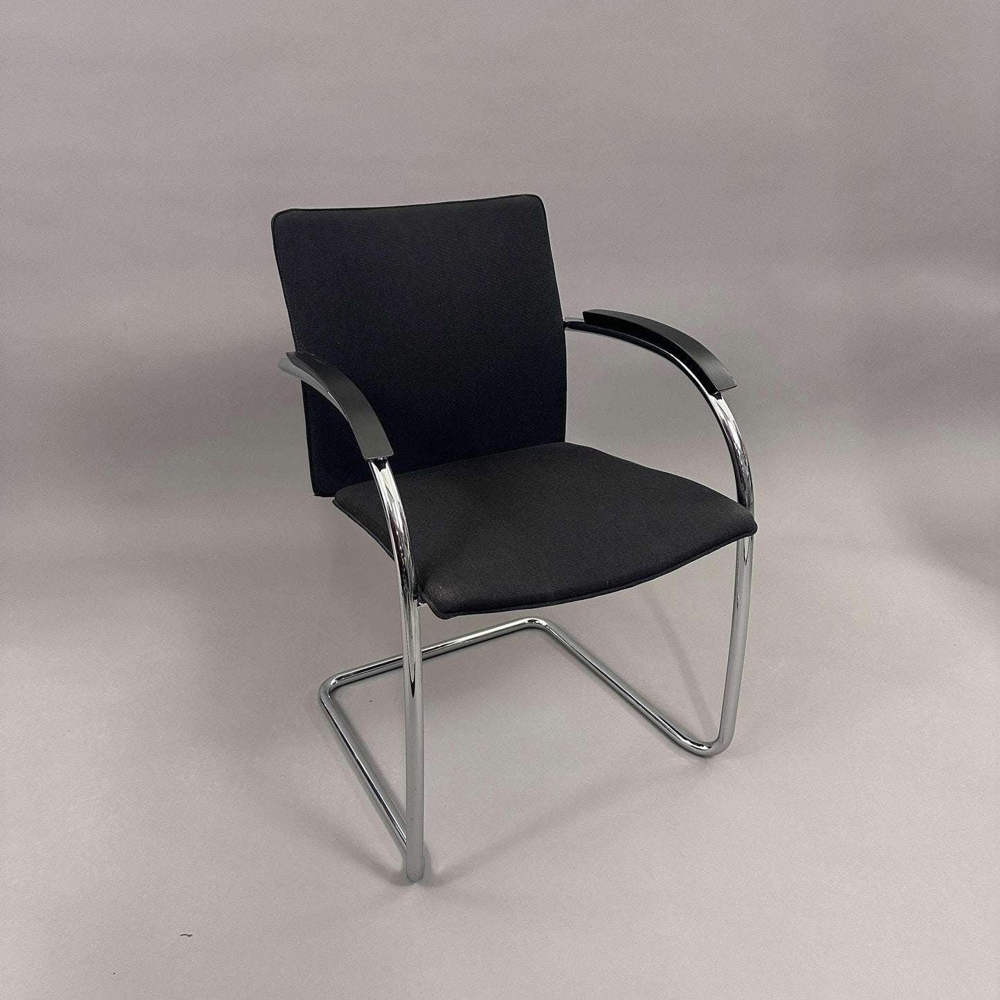 Black upholstered Thonet S78/S79 chair with matte black wooden armrests and chrome cantilever frame
