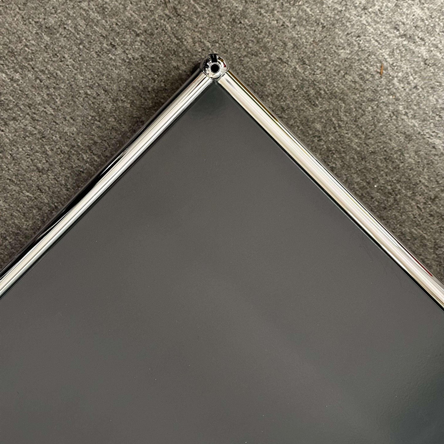 USM Haller Beistelltisch anthracite side table with chrome frame on gray carpet