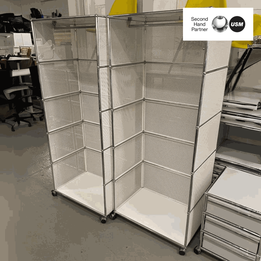 USM Haller Garderobe white modular shelving unit with chrome frame and mesh panels on wheels