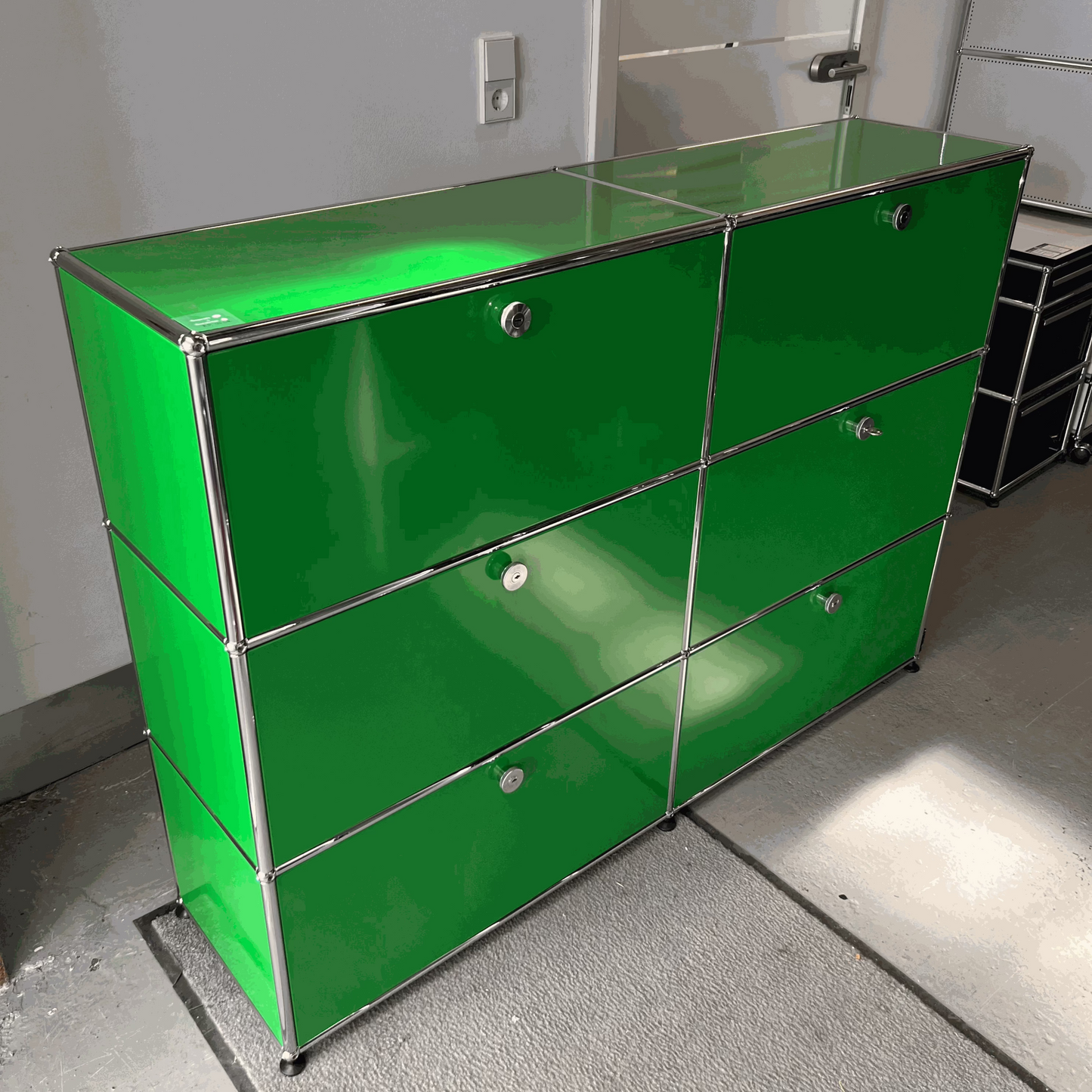 USM Haller green highboard with six soft-close compartments and metal frame
