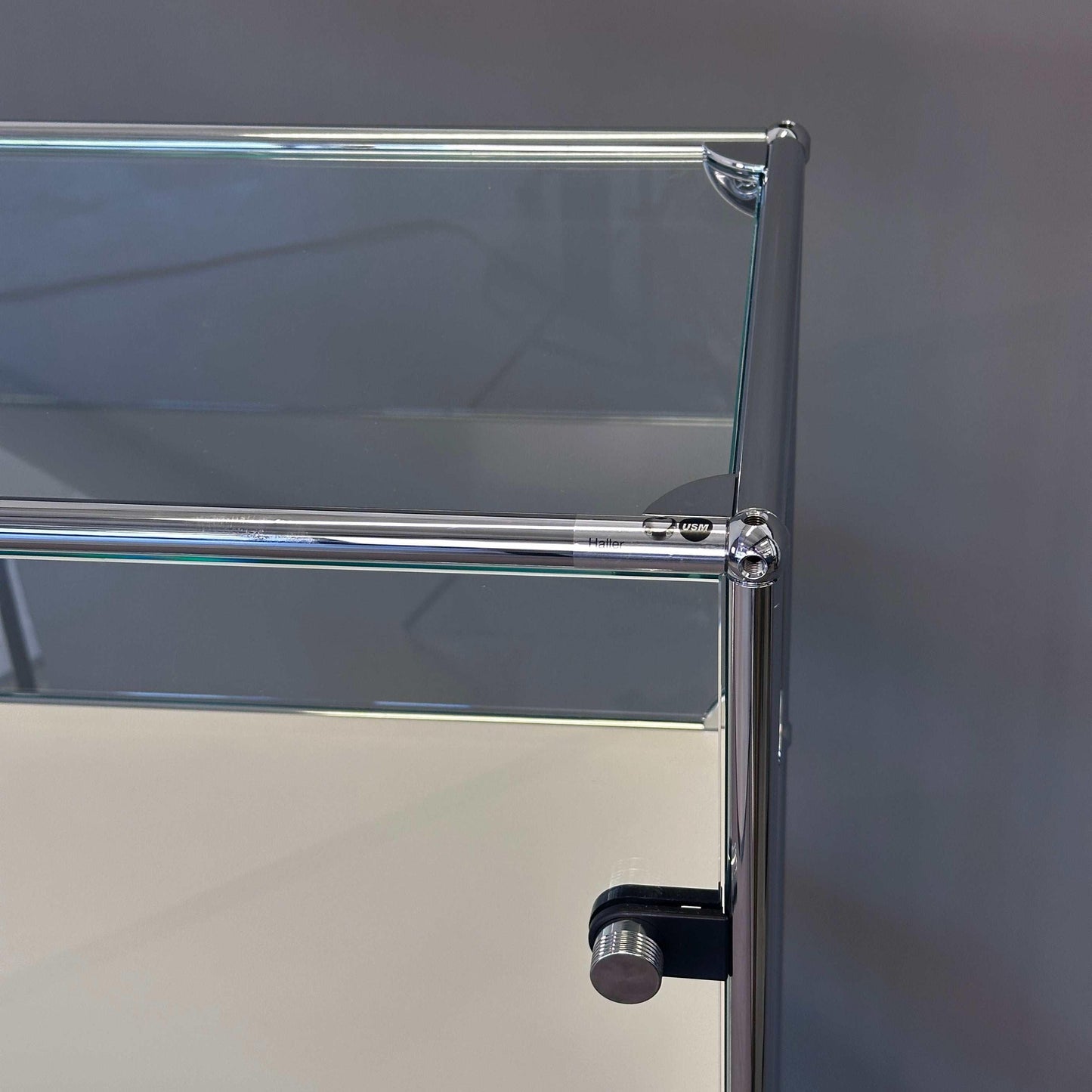 USM Haller Highboard Vitrine aus Glas mit weißen Fachböden und Chromrahmen in Reinweiß