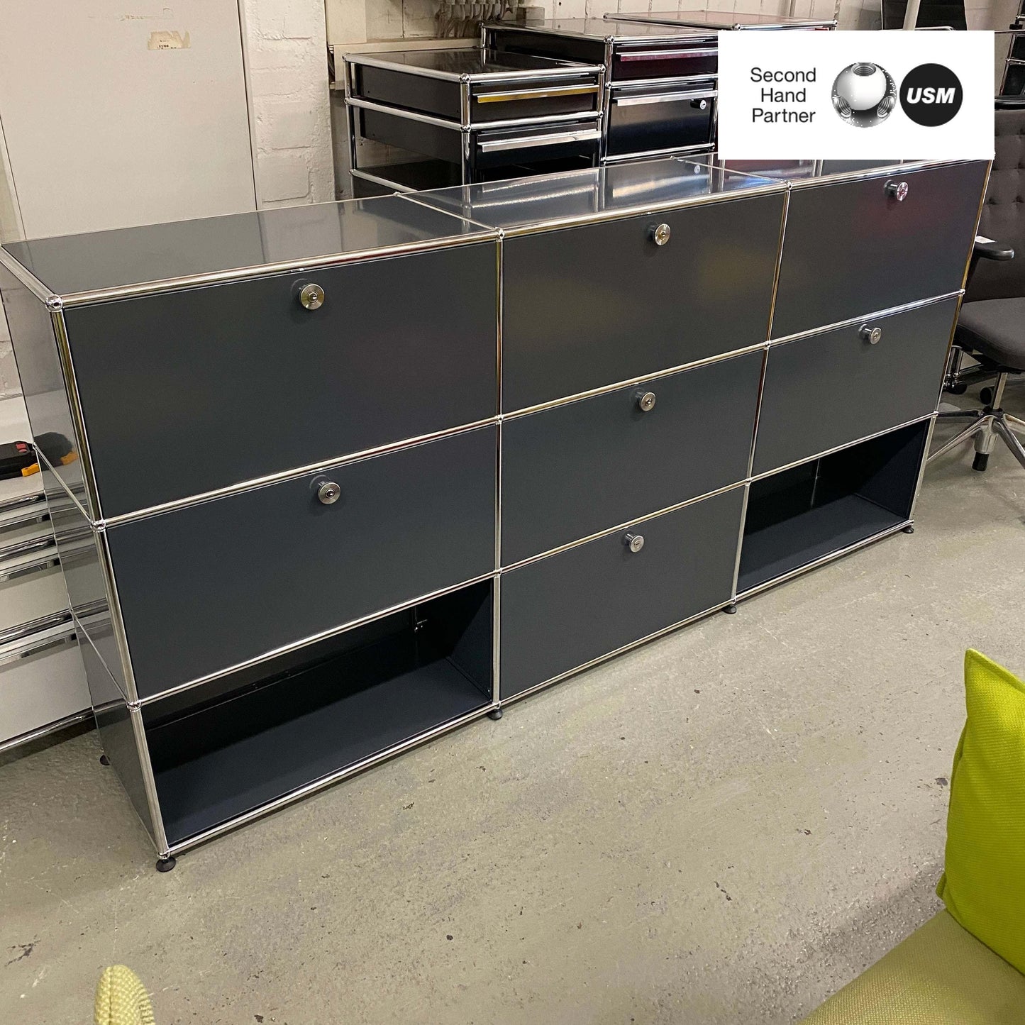 USM Haller anthracite highboard with 3x3 compartments, 6 flap doors, and 1 drawer, measuring 227x109x35cm