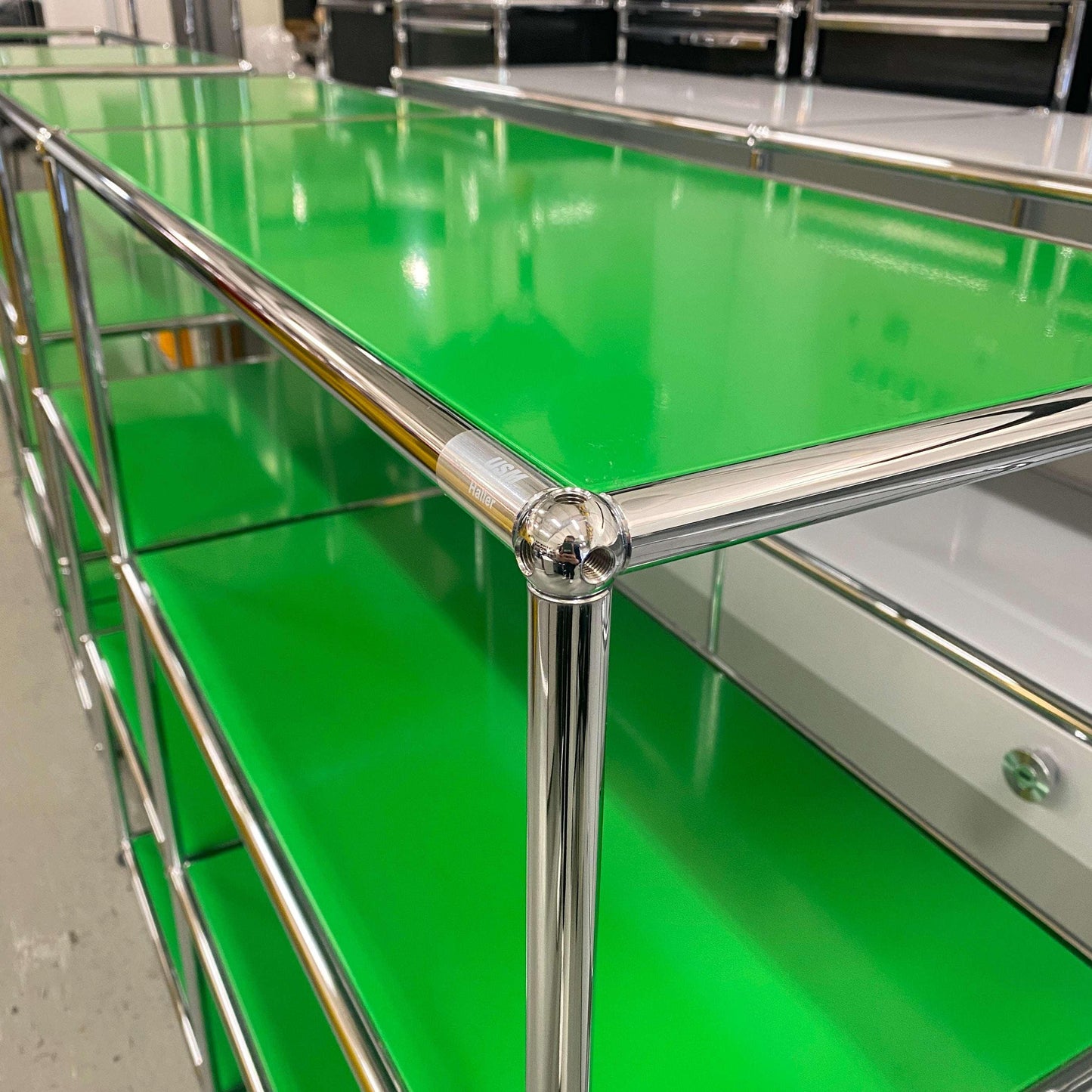 USM Haller Highboard in green with chrome frame, 2x3 open shelves, measuring 128x109x38 cm