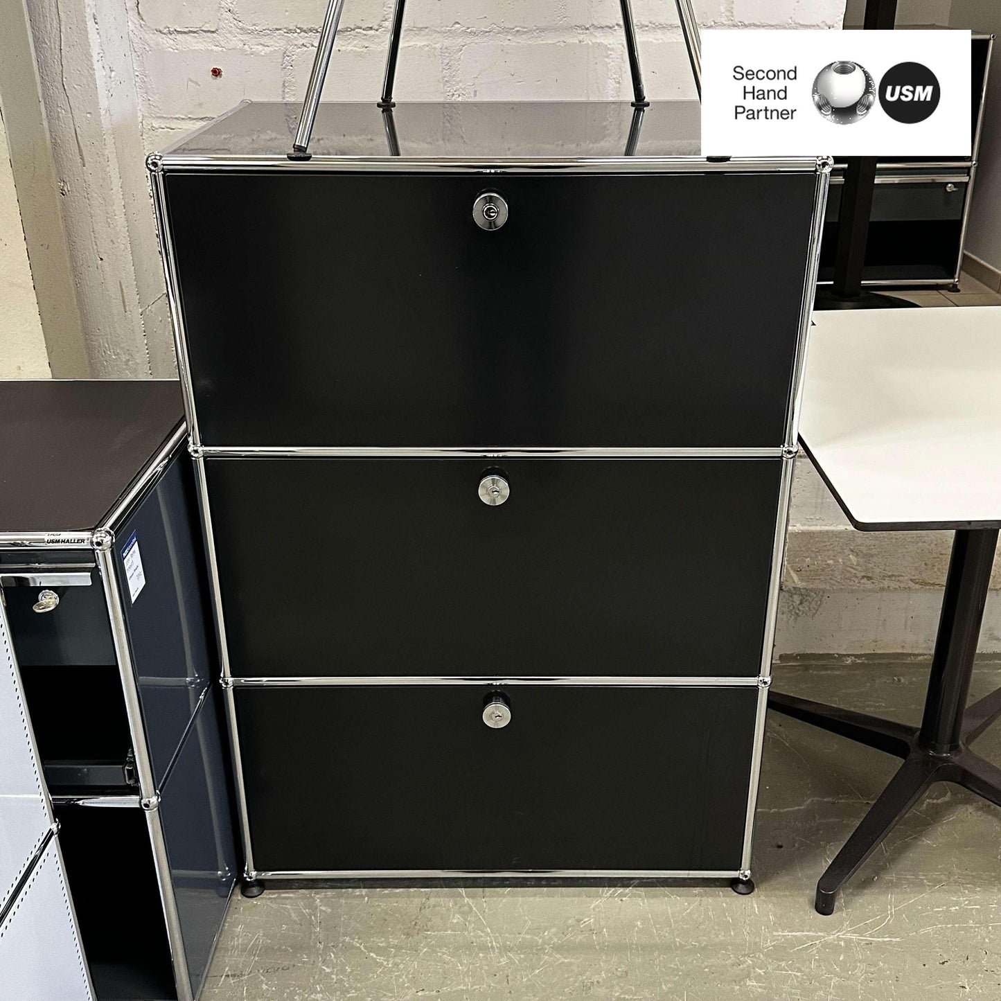 USM Haller Highboard in black with 1 drawer and 2 flap compartments, measuring 109x75x52 cm