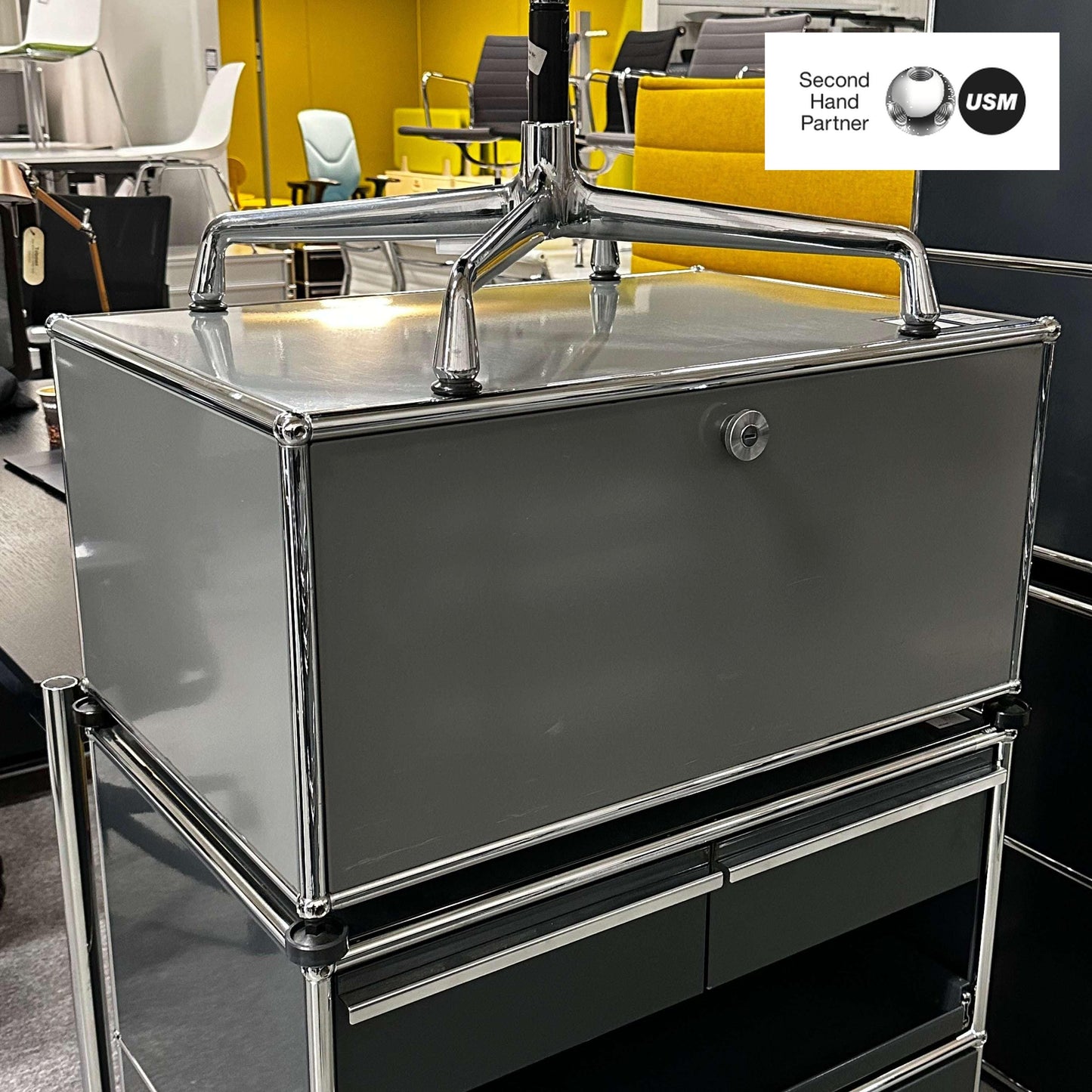 USM Haller lowboard in medium gray with one flap door and chrome frame, modern storage unit