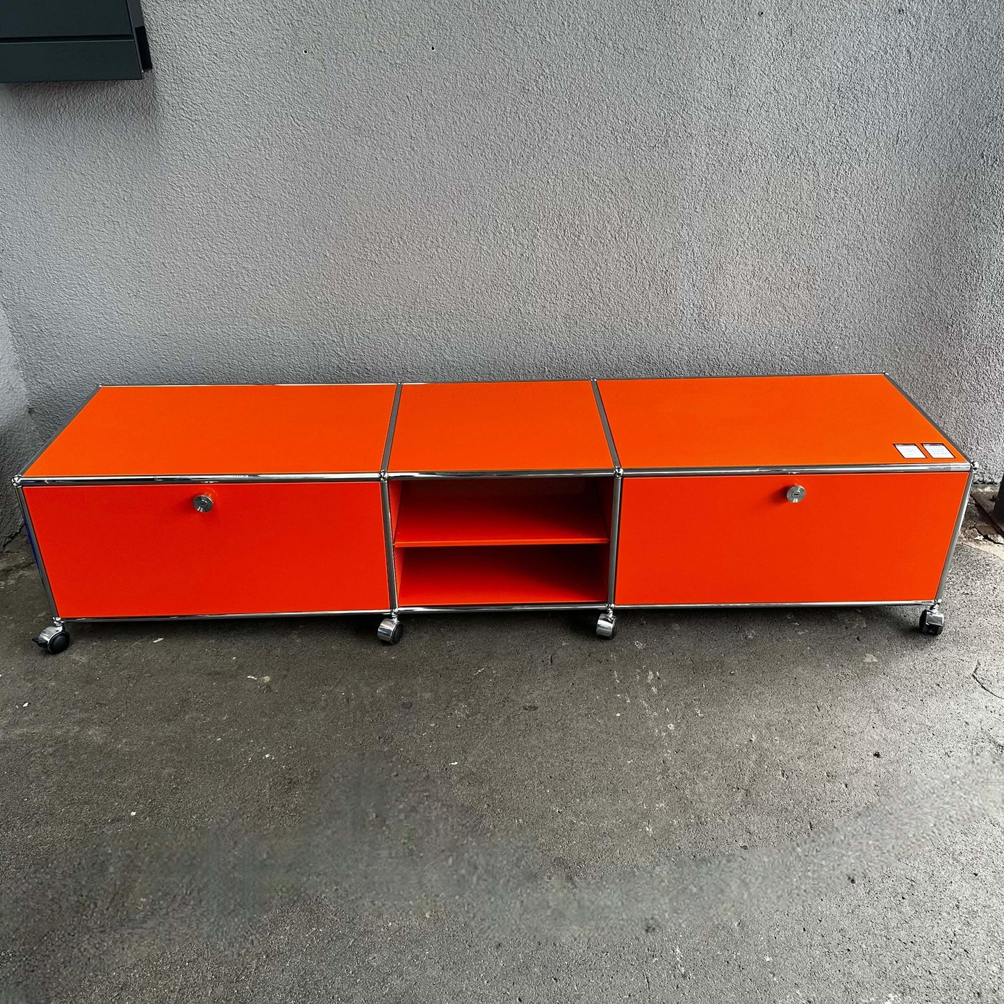 USM Haller Lowboard in reinorange with three compartments and casters, 202x43x52cm