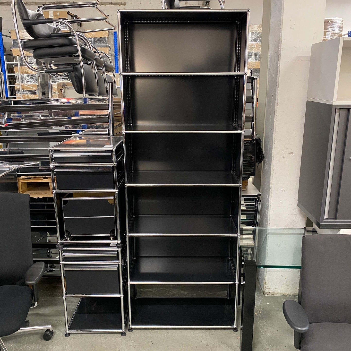 Black USM Haller Regal shelving unit with six shelves and metal frame, 214x78x38cm tall in storage room.