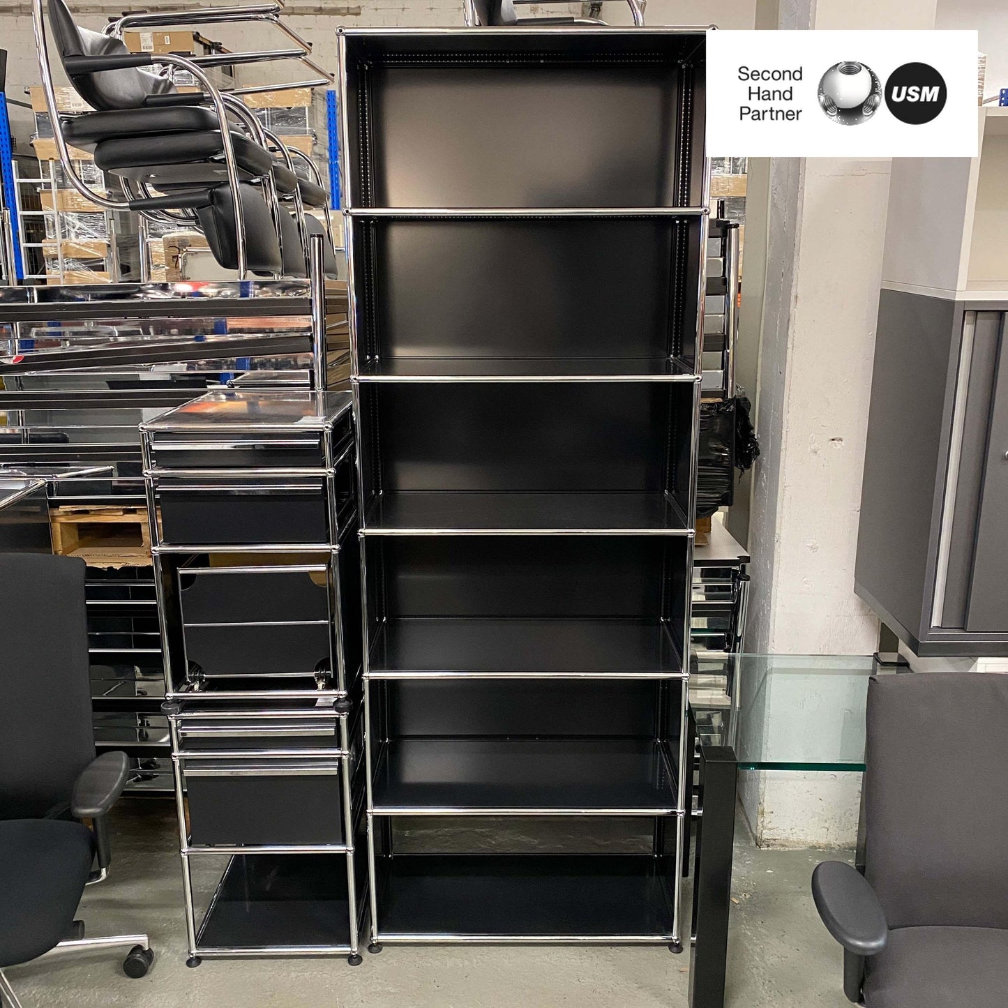 Black USM Haller Regal shelving unit with six shelves and metal frame, 214x78x38cm tall in storage room.
