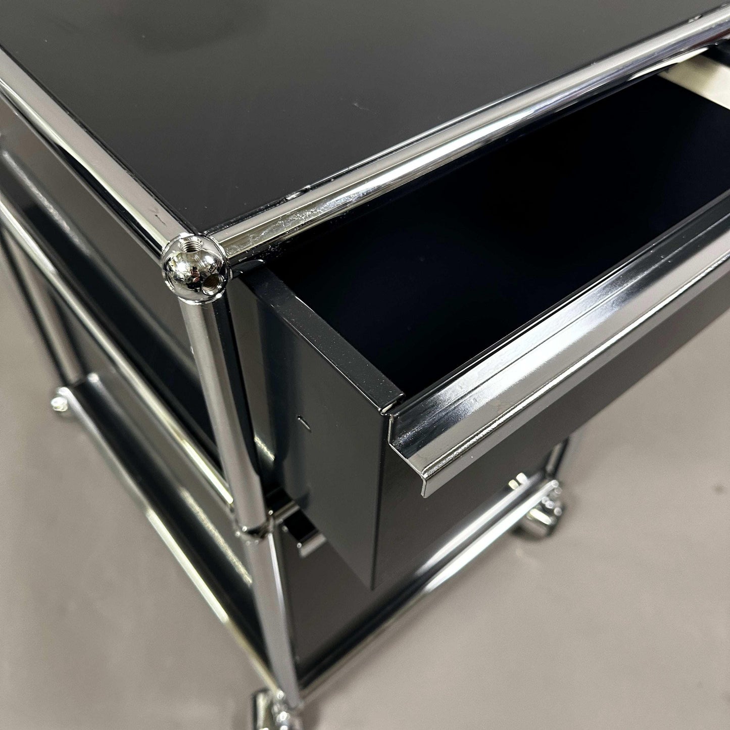 USM Haller Rollcontainer in graphite black with two drawers and chrome frame detail