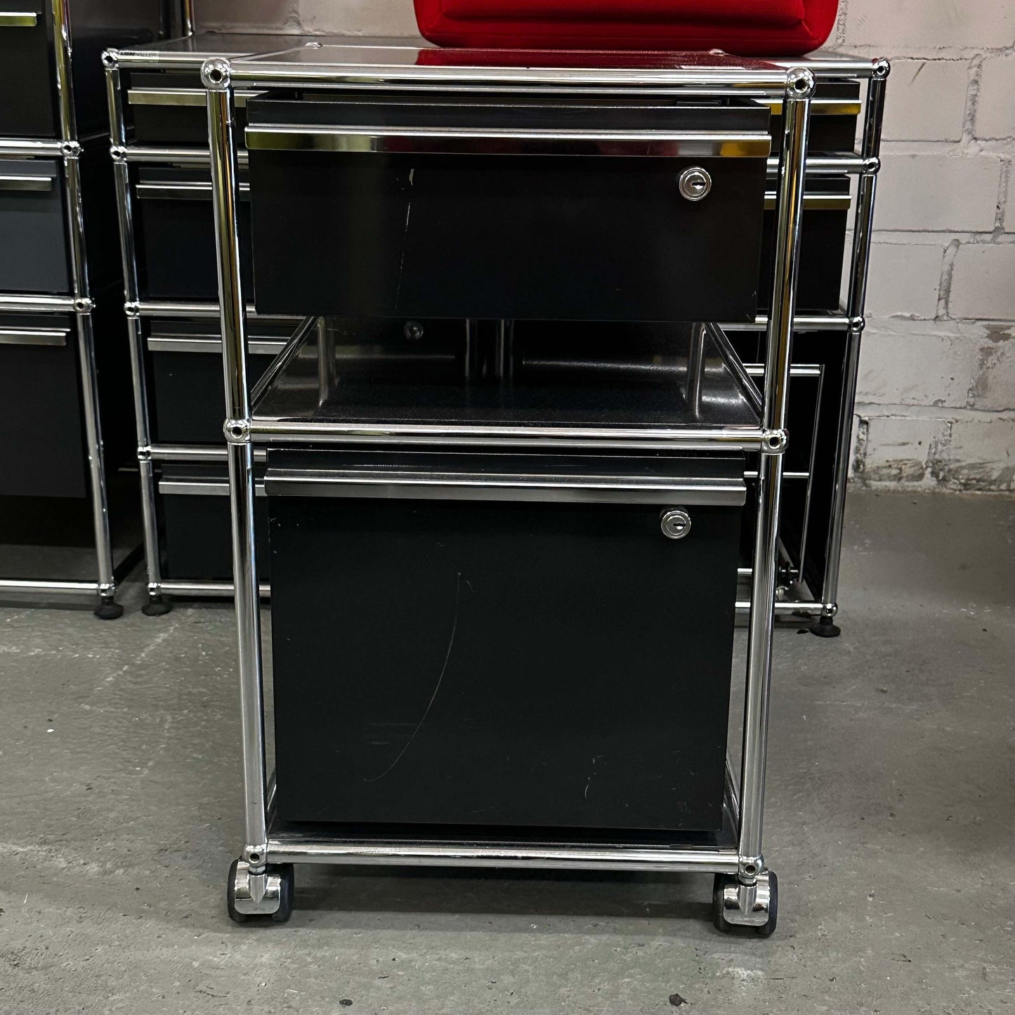 USM Haller black rollcontainer with two drawers and chrome frame on casters