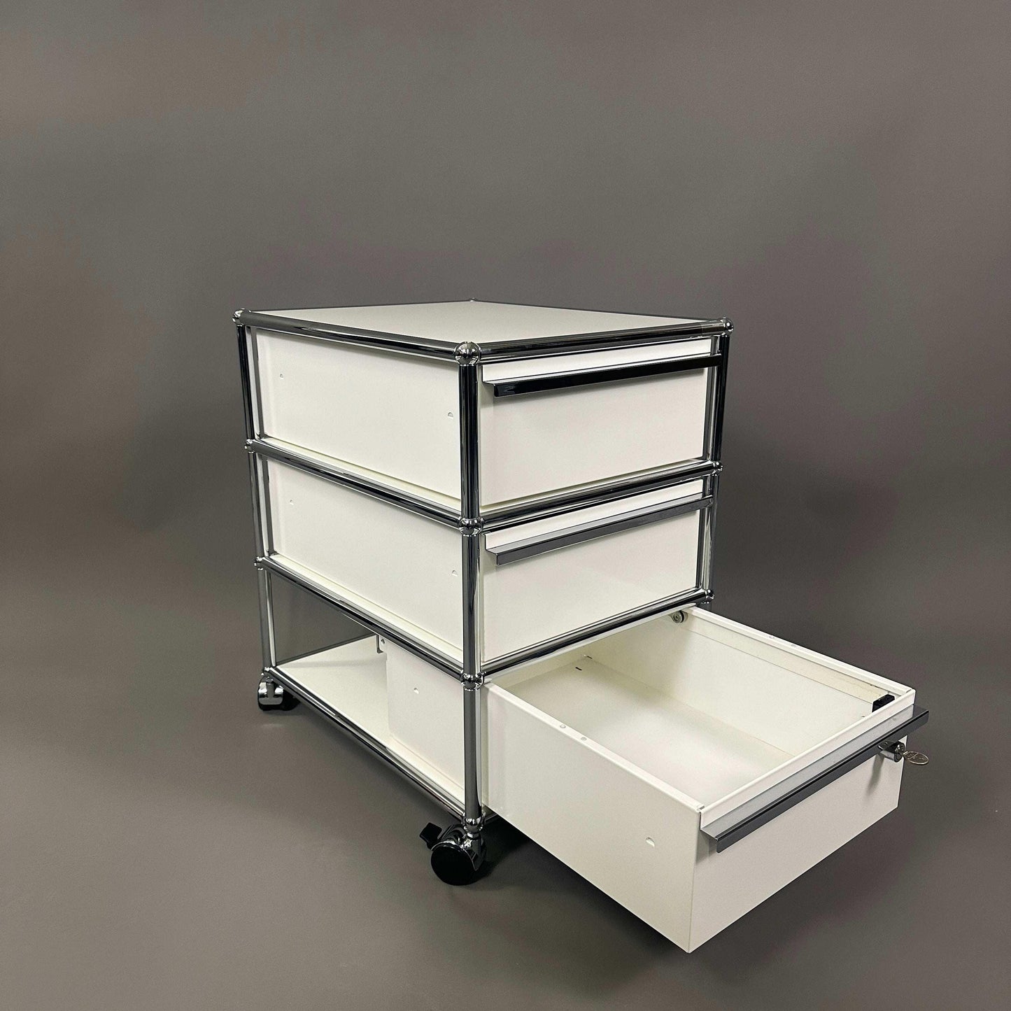 USM Haller Rollcontainer white 3-drawer mobile storage unit with metal frame and caster wheels