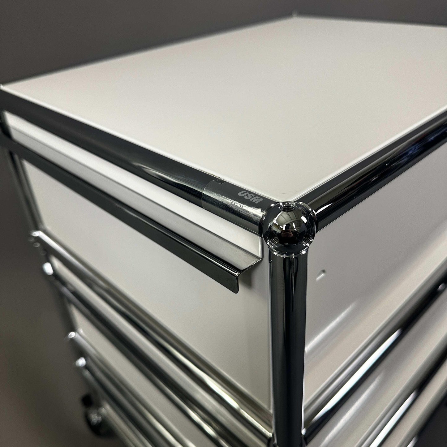 USM Haller Rollcontainer in white with three drawers and chrome frame detail
