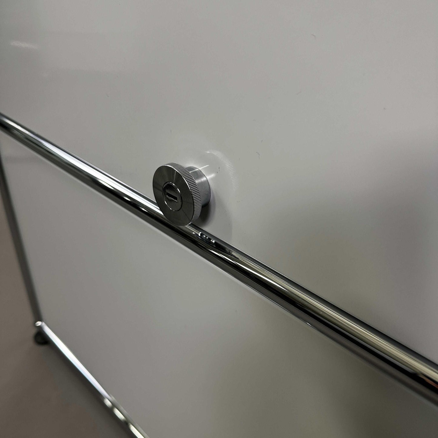 USM Haller light gray sideboard with 1x2 compartments and chrome handles close-up